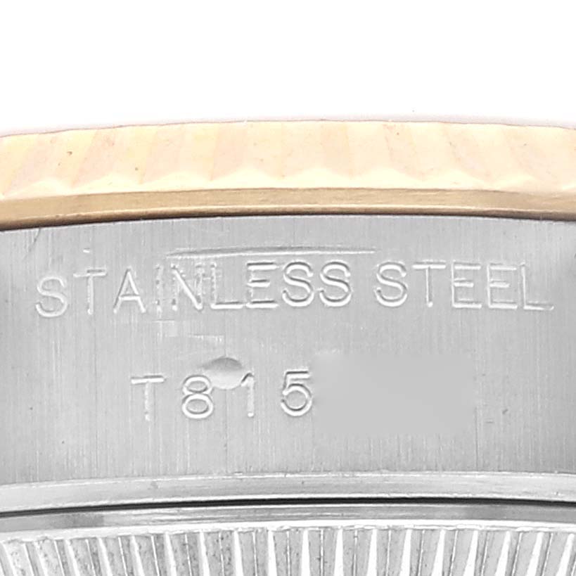 The image shows a close-up view of the side of the Rolex Datejust 69173 Women's Steel and Gold (two tone) White Dial 69173 Women's Steel and Gold (two tone) White Dial watch case, highlighting the stainless steel and engraving.