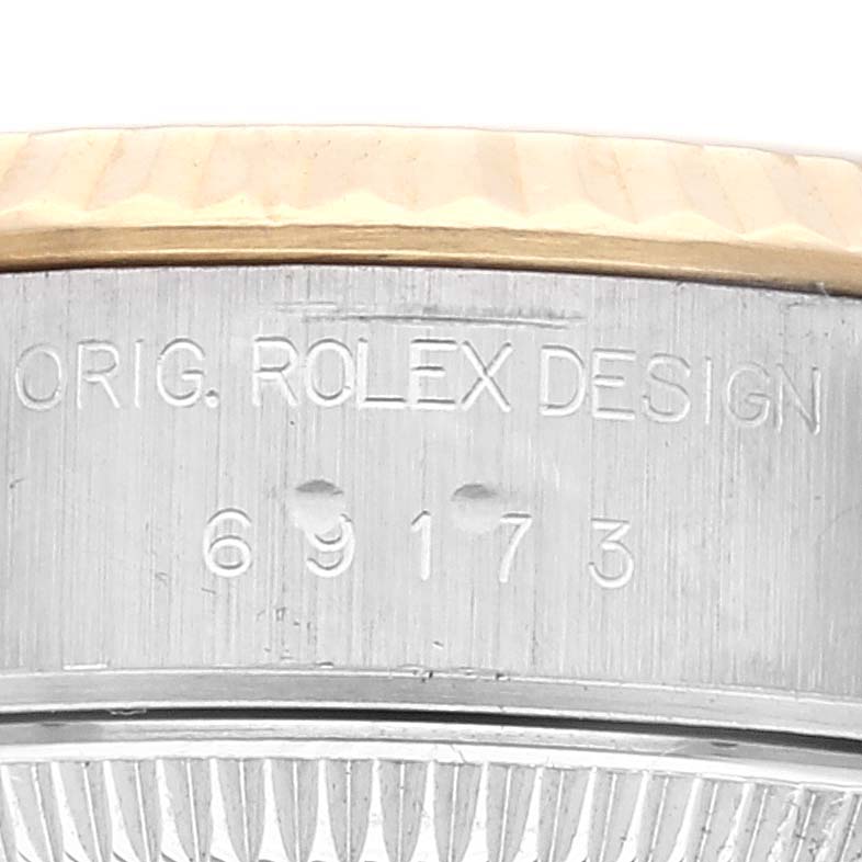 The image shows a close-up of the side of a Rolex Datejust 69173 Women's Steel and Gold (two tone) White Dial 69173 Women's Steel and Gold (two tone) White Dial watch case with engraved details and model number 69173.