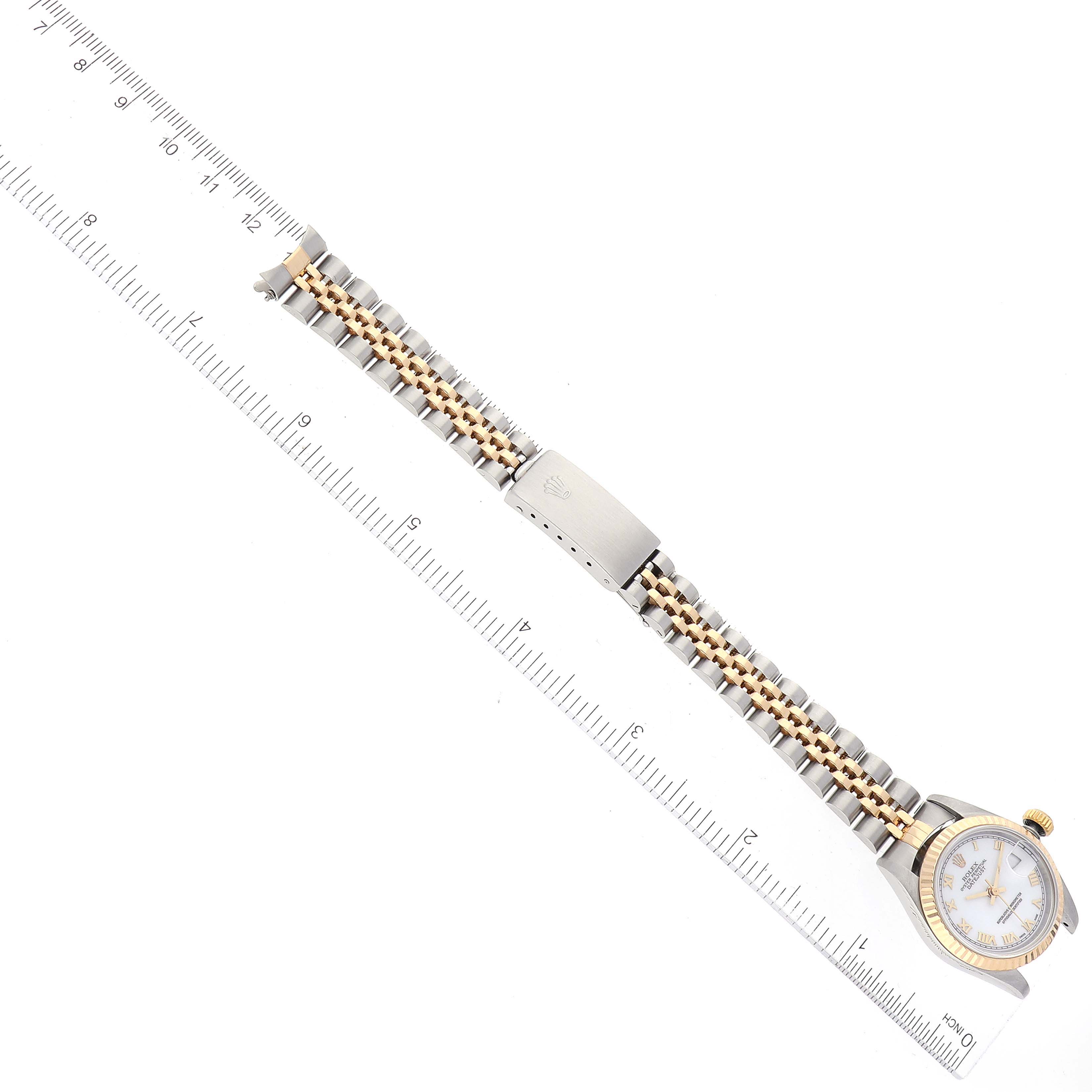 The image shows a Rolex Datejust 69173 Women's Steel and Gold (two tone) White Dial 69173 Women's Steel and Gold (two tone) White Dial watch laid flat next to a ruler, highlighting its bracelet and clasp.