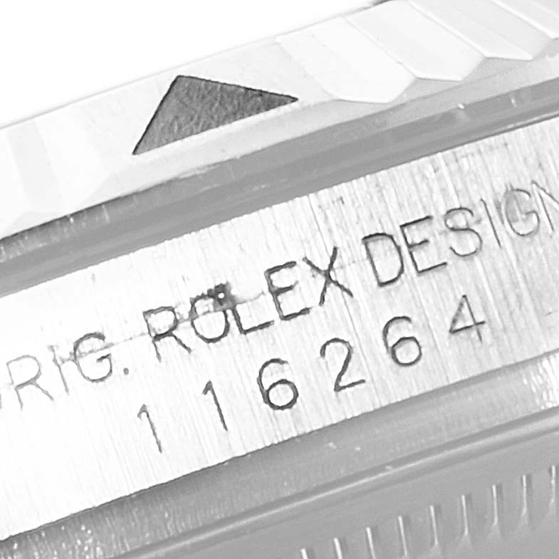 The image shows a close-up angle of the bezel and serial number engraving on a Rolex Turn-o-Graph 116264 Men's Stainless Steel Black Dial 116264 Men's Stainless Steel Black Dial watch.
