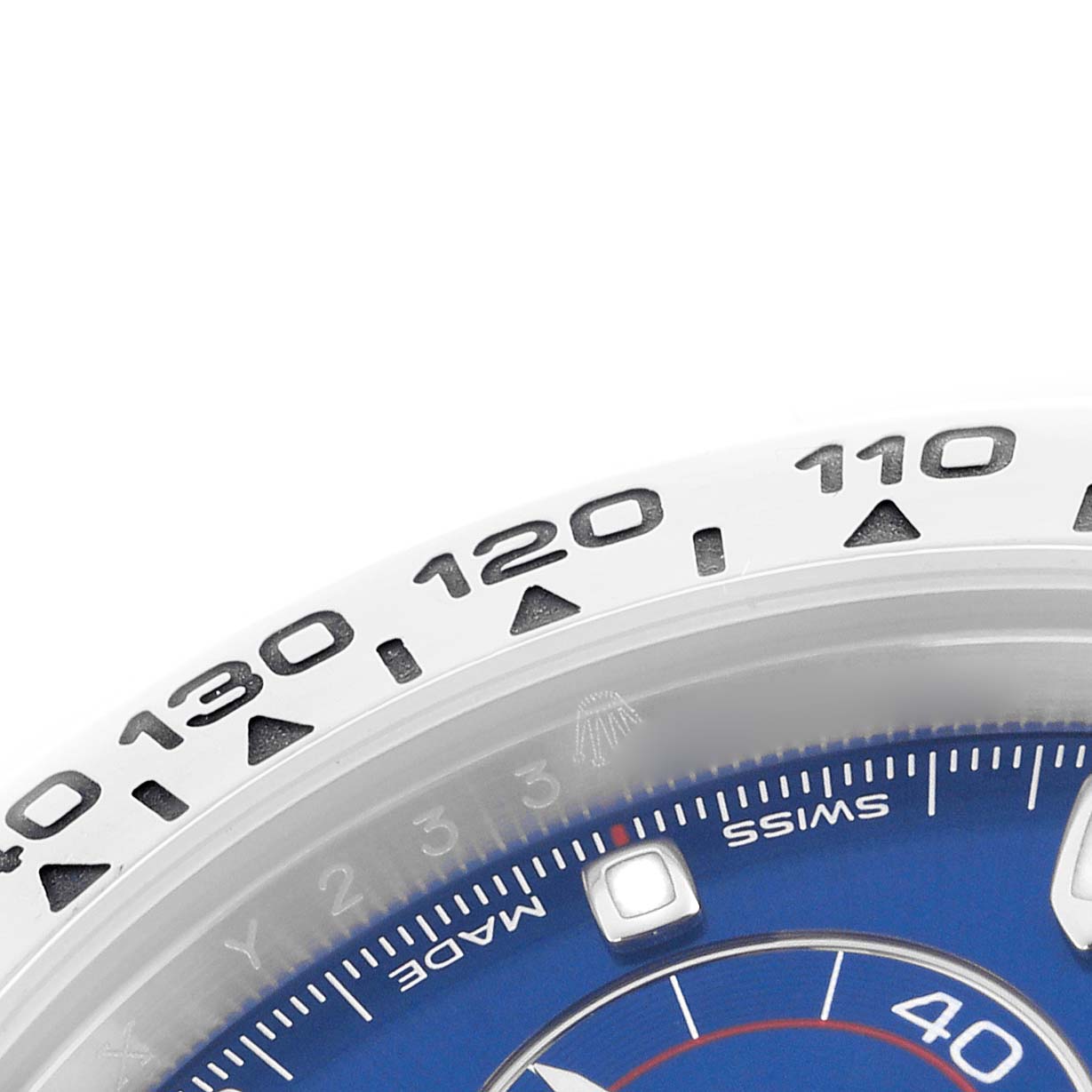 The image shows a close-up of the bezel and part of the dial of a Rolex Daytona 116509 Men
s White Gold Blue Dial 116509 Men
s White Gold Blue Dial, with visible tachymetric scale markings.