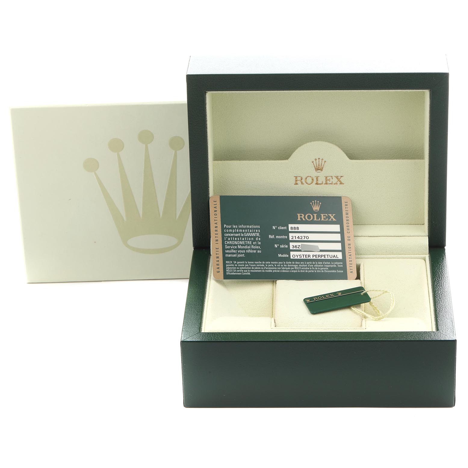 The image shows a Rolex Explorer 214270 Men
s Stainless Steel Black Dial 214270 Men
s Stainless Steel Black Dial watch box, warranty card, and a tag, all top-down view.