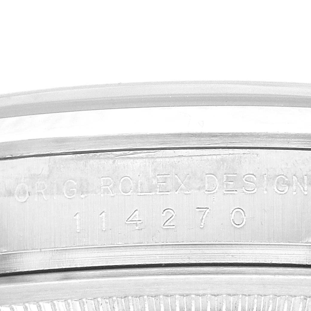 The image shows the serial number engraving on the side of a Rolex Explorer 114270 Men
s Stainless Steel Black Dial 114270 Men
s Stainless Steel Black Dial watch case.