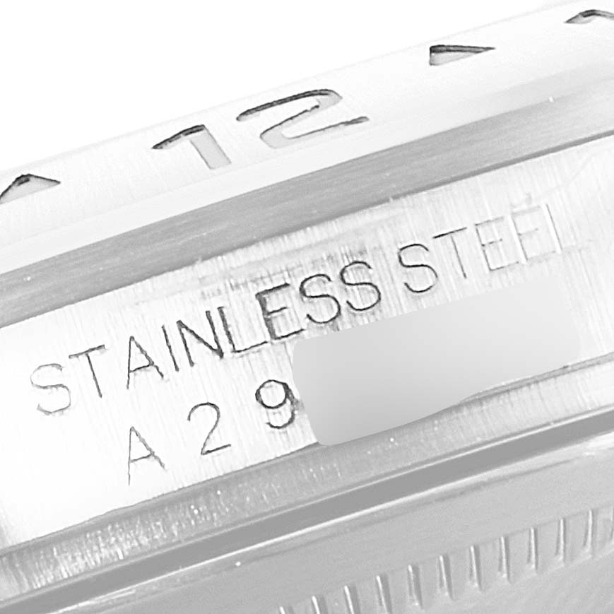 The image shows a close-up of the bezel and case of a Rolex Explorer 16570 Men's Stainless Steel White Dial 16570 Men's Stainless Steel White Dial watch, highlighting the "STAINLESS STEEL" and part of the serial number.