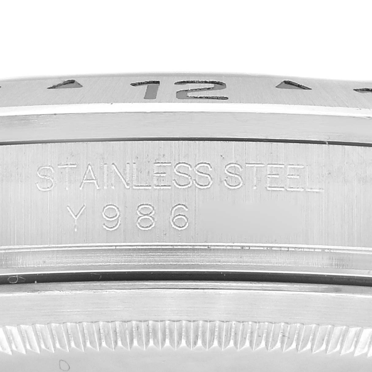 This close-up image shows the side profile of the stainless steel casing of a Rolex Explorer 16570 Men's Stainless Steel Black Dial 16570 Men's Stainless Steel Black Dial watch, revealing "STAINLESS STEEL" and serial number engraving.