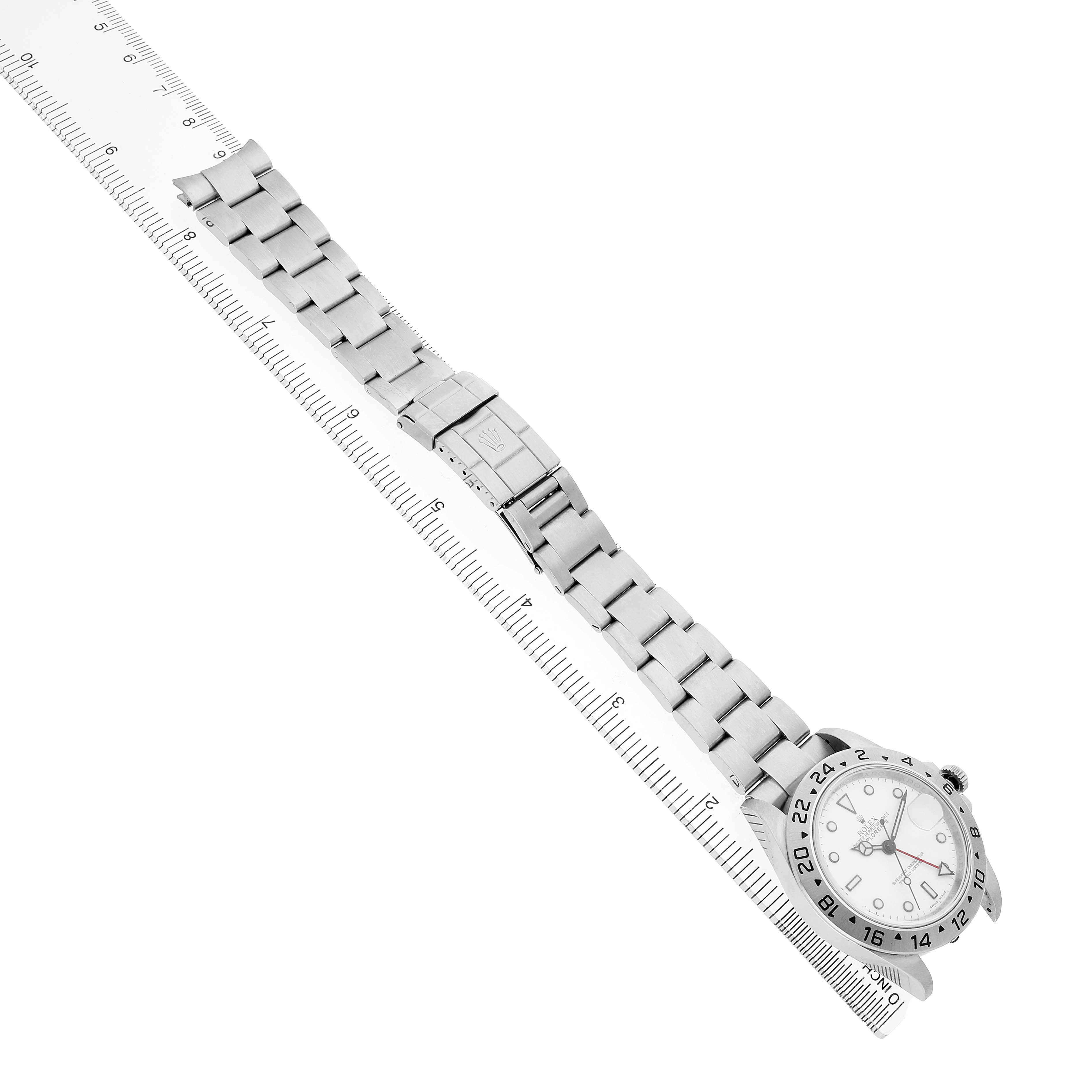 The image shows a side view of the Rolex Explorer 16570 Men's Stainless Steel White Dial watch and its full metal bracelet aligned with a ruler.