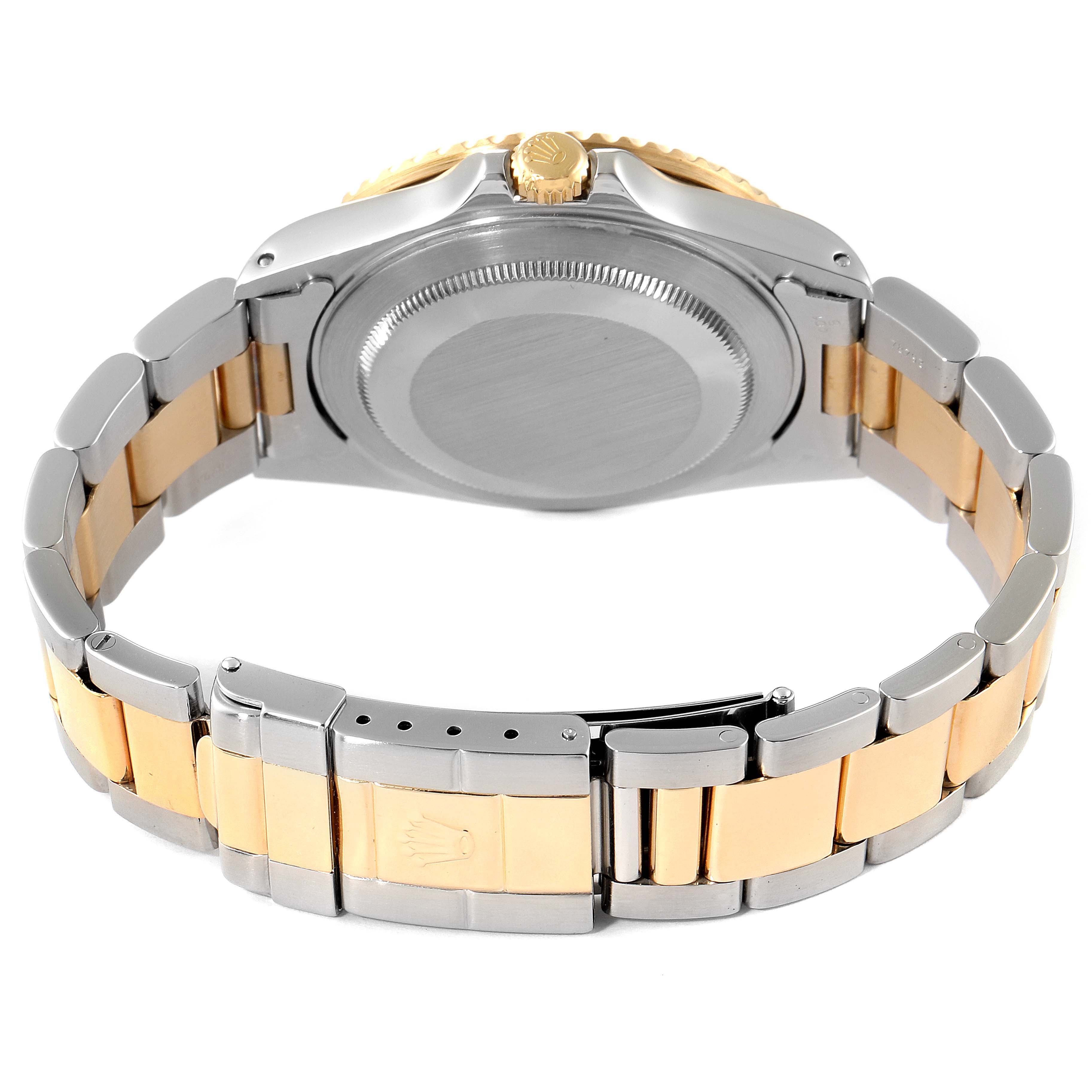 This image shows the back and clasp of a Rolex GMT-Master 16713 Men's Steel and Gold (two tone) Black Dial 16713 Men's Steel and Gold (two tone) Black Dial watch with a two-tone metal bracelet.