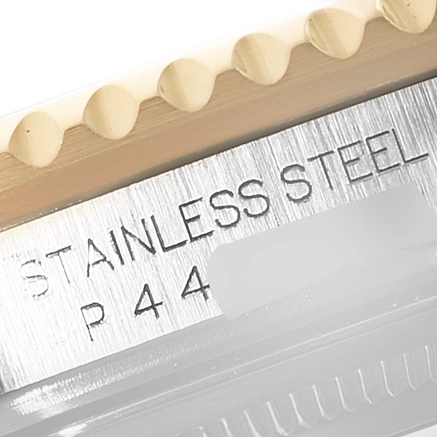 Close-up of the engraving and bezel teeth of a Rolex GMT-Master 16713 Men's Steel and Gold (two tone) Black Dial 16713 Men's Steel and Gold (two tone) Black Dial watch, highlighting the "Stainless Steel" text.