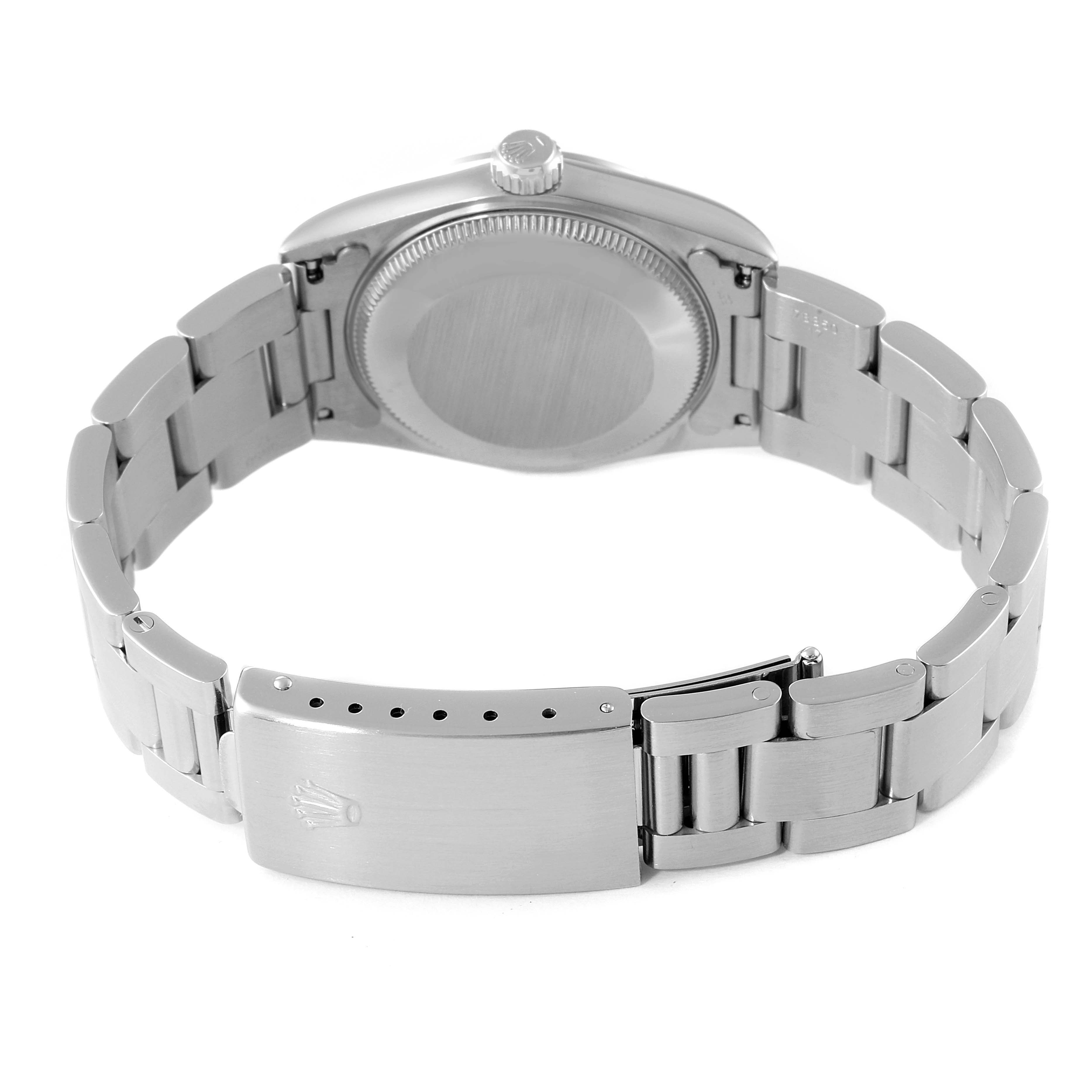 This Rolex Mid-Size 67480 Women's Stainless Steel Blue Dial 67480 Women's Stainless Steel Blue Dial model watch is shown from the back, highlighting the case back, crown, and bracelet with the clasp.