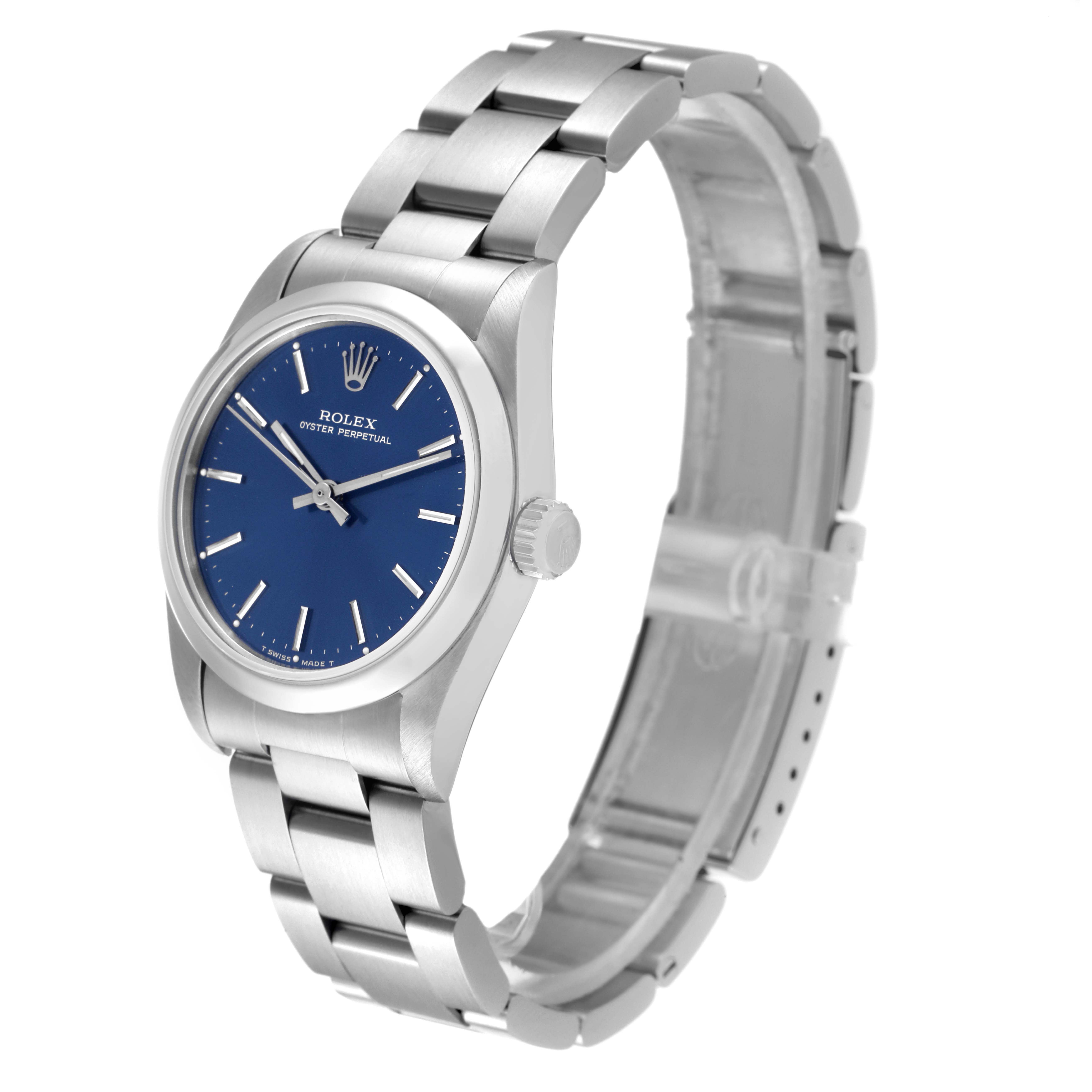 The image shows a side-angle view of a Rolex Mid-Size 67480 Women's Stainless Steel Blue Dial 67480 Women's Stainless Steel Blue Dial Oyster Perpetual watch, highlighting the bracelet, bezel, and dial.