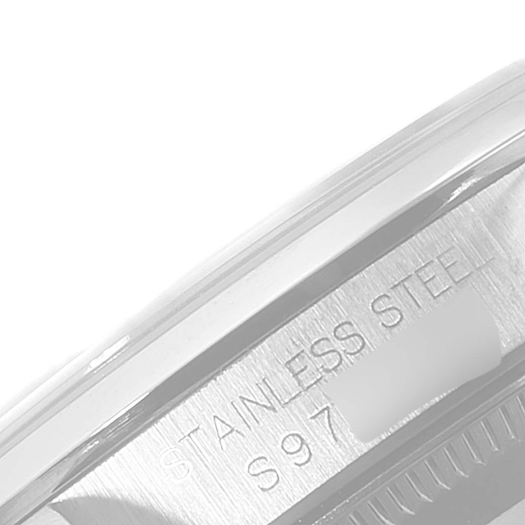 The image shows a close-up angle of the case back of a Mid-Size Rolex watch, highlighting the "STAINLESS STEEL" engraving.
