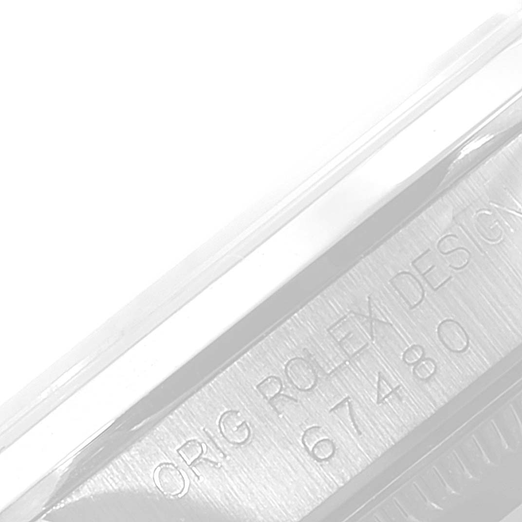 This image shows a close-up of the inscription on the side of a Rolex Mid-Size 67480 Women's Stainless Steel Blue Dial 67480 Women's Stainless Steel Blue Dial model watch case.