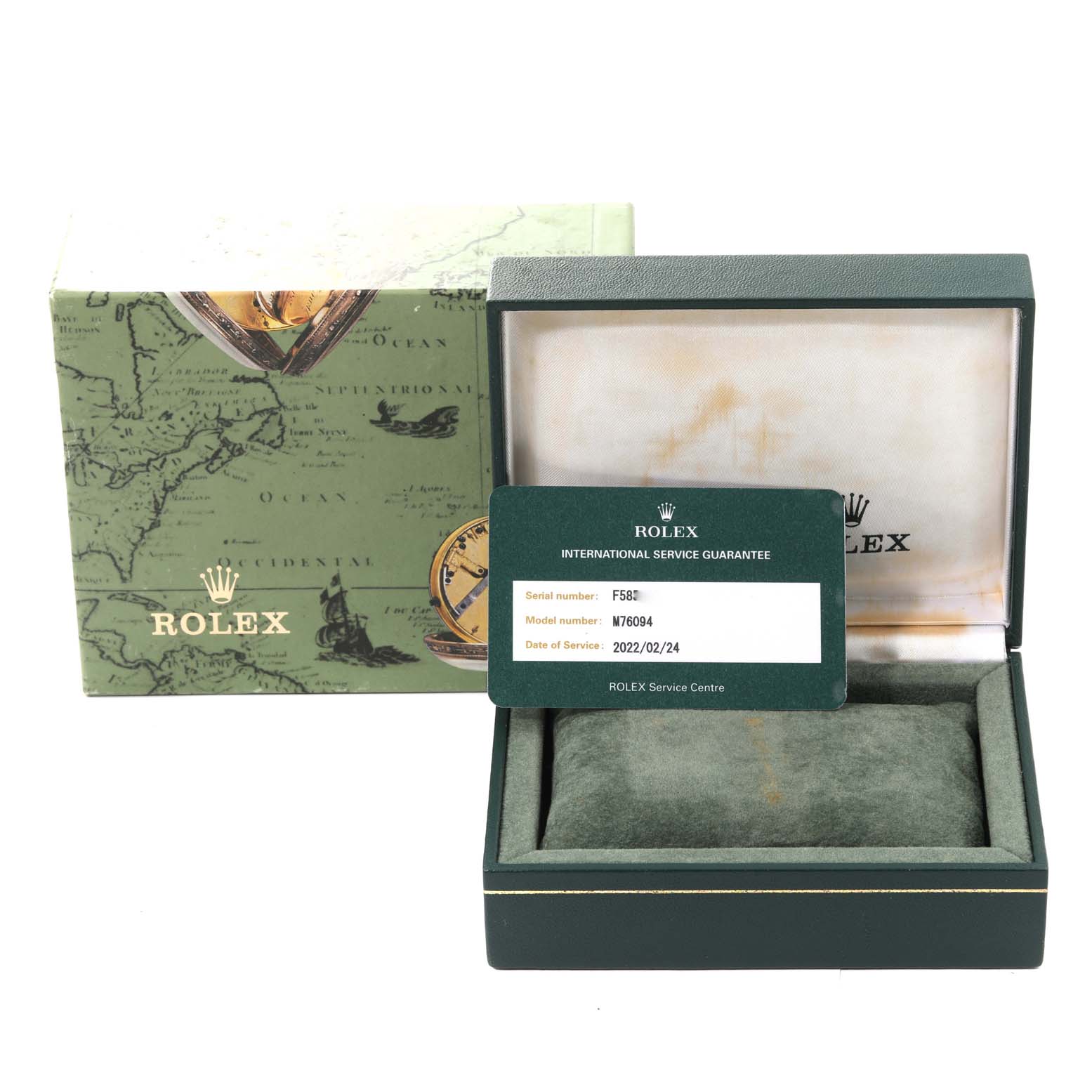 The image shows a Rolex Oyster Perpetual M76094 Women's Stainless Steel Black Dial M76094 Women's Stainless Steel Black Dial box, open with an international service guarantee card.