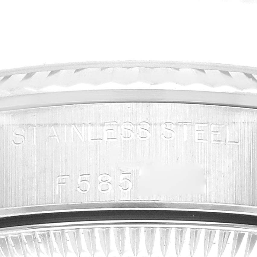 This close-up image shows the side engraving and bezel teeth of a Rolex Oyster Perpetual M76094 Women's Stainless Steel Black Dial M76094 Women's Stainless Steel Black Dial watch.