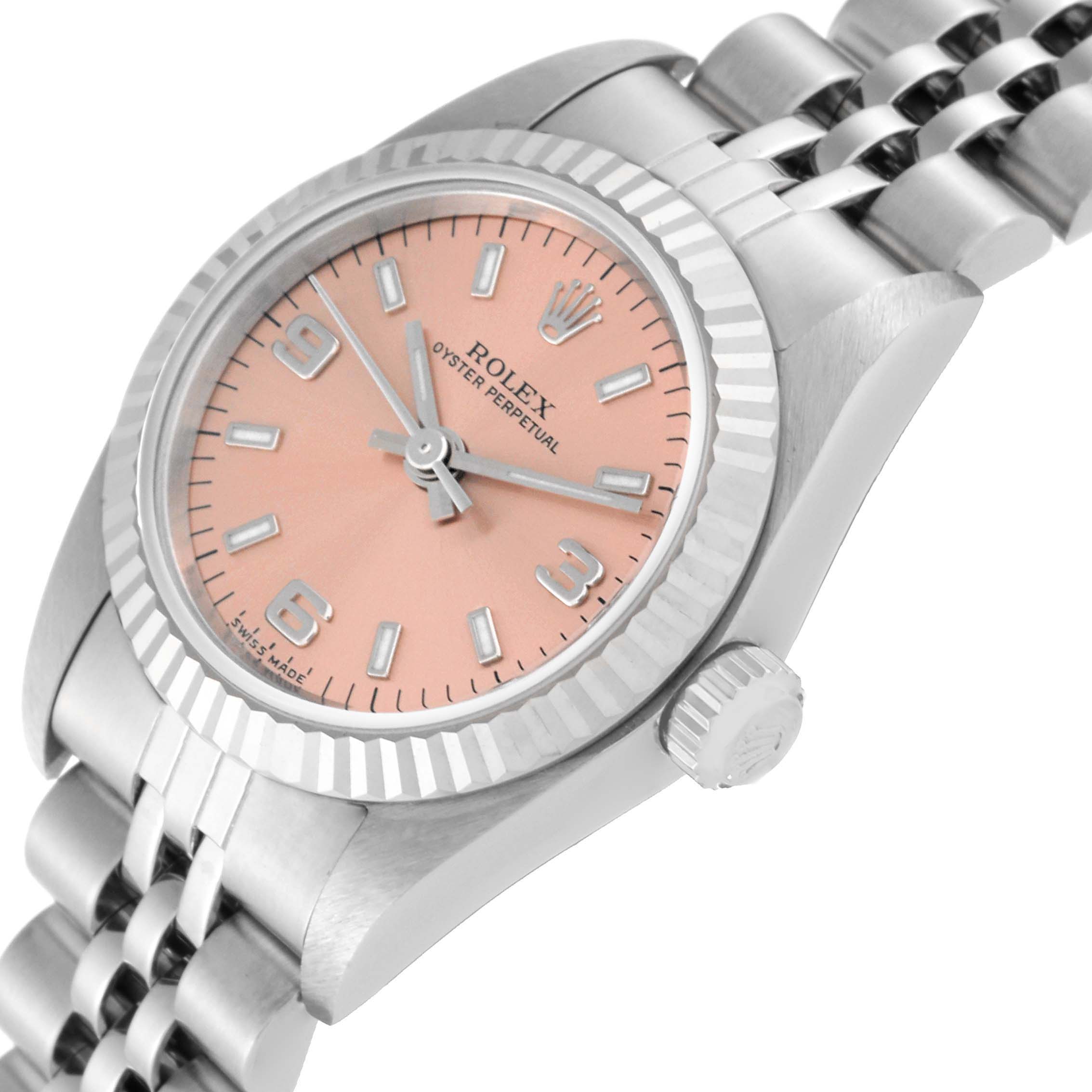 The Rolex Oyster Perpetual 76094 Women's Stainless Steel Pink Dial 76094 Women's Stainless Steel Pink Dial watch is shown from an angled view, displaying its dial, case, crown, and part of the bracelet.