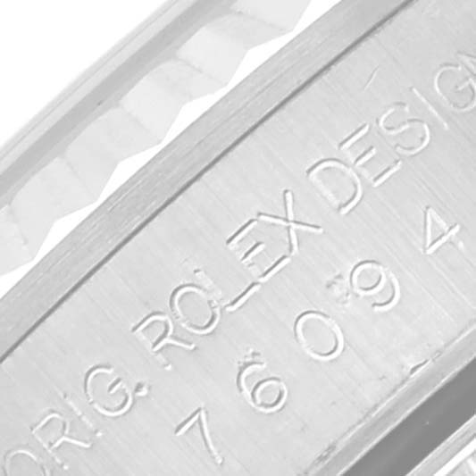 This close-up image shows the side engraving of a Rolex Oyster Perpetual 76094 Women's Stainless Steel Pink Dial 76094 Women's Stainless Steel Pink Dial watch case, displaying the model number.