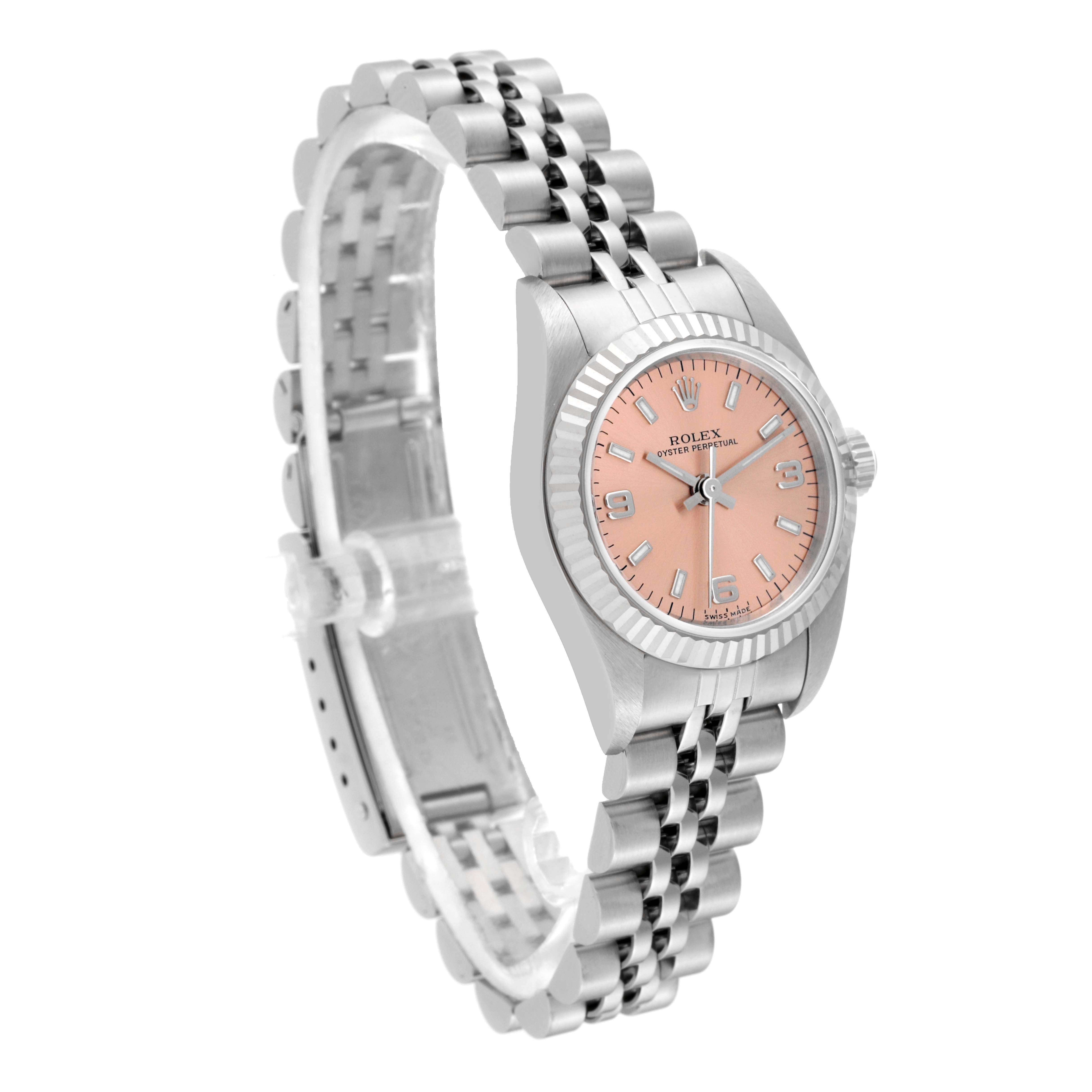 This image shows a Rolex Oyster Perpetual 76094 Women's Stainless Steel Pink Dial 76094 Women's Stainless Steel Pink Dial watch at a three-quarter angle, highlighting its face, bezel, and bracelet.