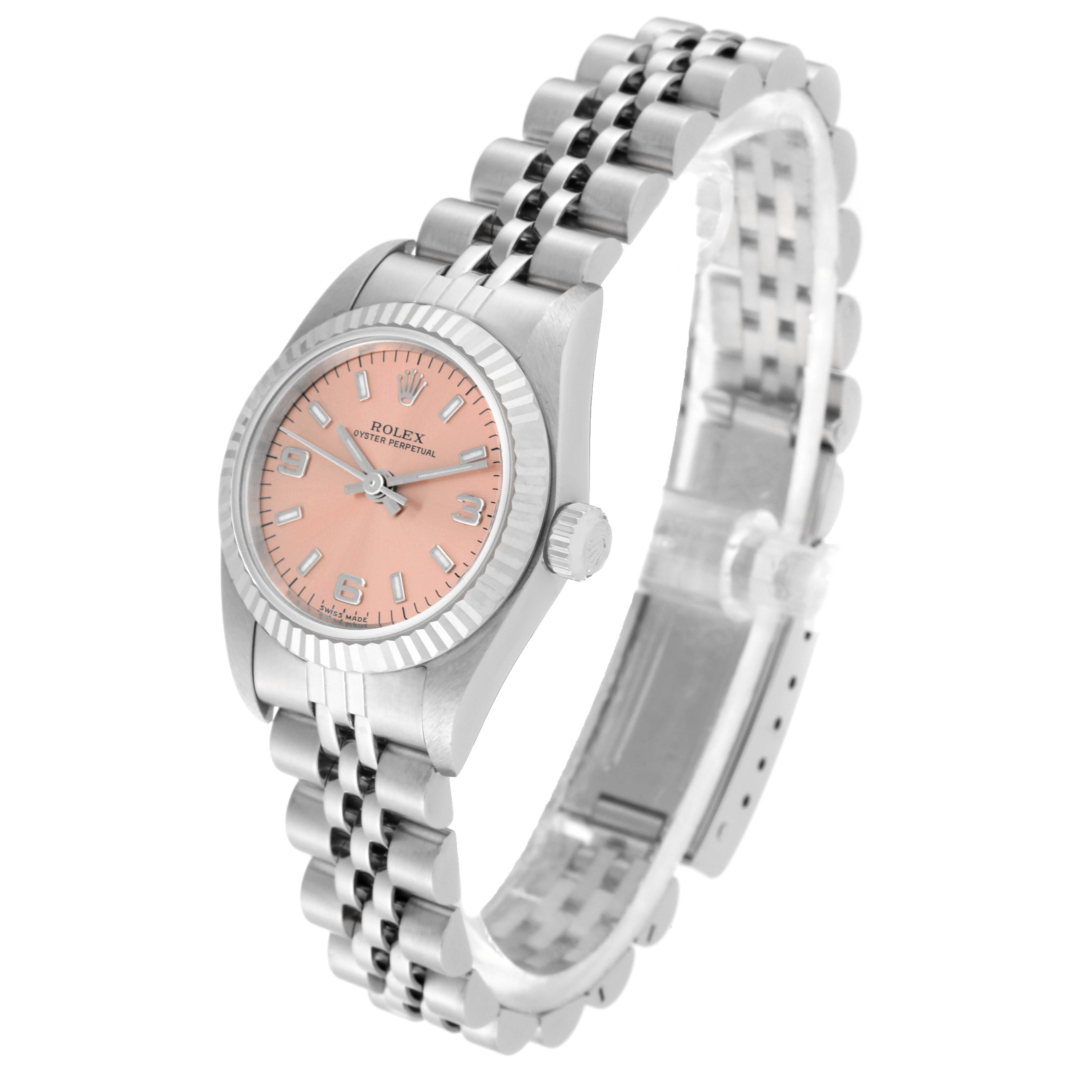 The image shows a side angle of a Rolex Oyster Perpetual 76094 Women's Stainless Steel Pink Dial 76094 Women's Stainless Steel Pink Dial watch with a pink dial and silver jubilee bracelet.