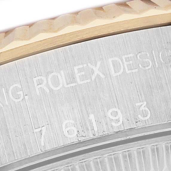 This close-up shows the engraved model number on the casing and part of the bezel of a Rolex Oyster Perpetual 76193 Women's Steel and Gold (two tone) Silver Dial 76193 Women's Steel and Gold (two tone) Silver Dial watch.