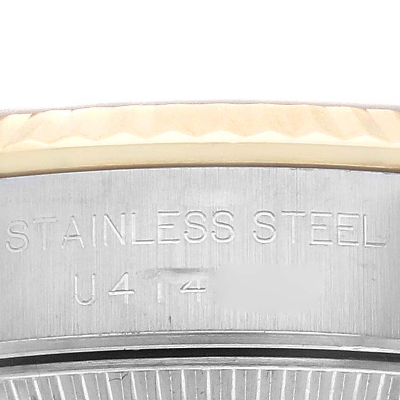 This image shows a close-up of the side engraving on a Rolex Oyster Perpetual 67193 Women's Steel and Gold (two tone) Champagne Dial 67193 Women's Steel and Gold (two tone) Champagne Dial watch, highlighting the "Stainless Steel" text.