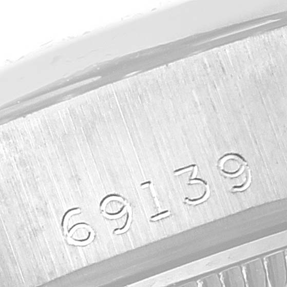 This image shows a close-up of the serial number engraving on the President model by Rolex.