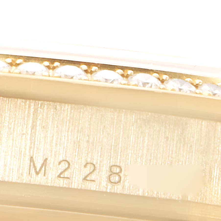This close-up image of a Rolex President 118388 Men's Yellow Gold Champagne Dial 118388 Men's Yellow Gold Champagne Dial model shows the bezel with diamonds and part of the engraved model number.