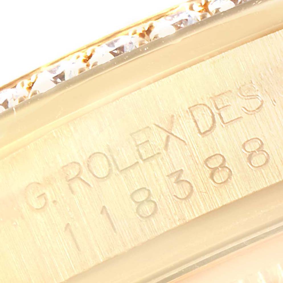 This close-up image shows part of the bezel and case with engraving on a Rolex President 118388 Men's Yellow Gold Champagne Dial 118388 Men's Yellow Gold Champagne Dial model watch.
