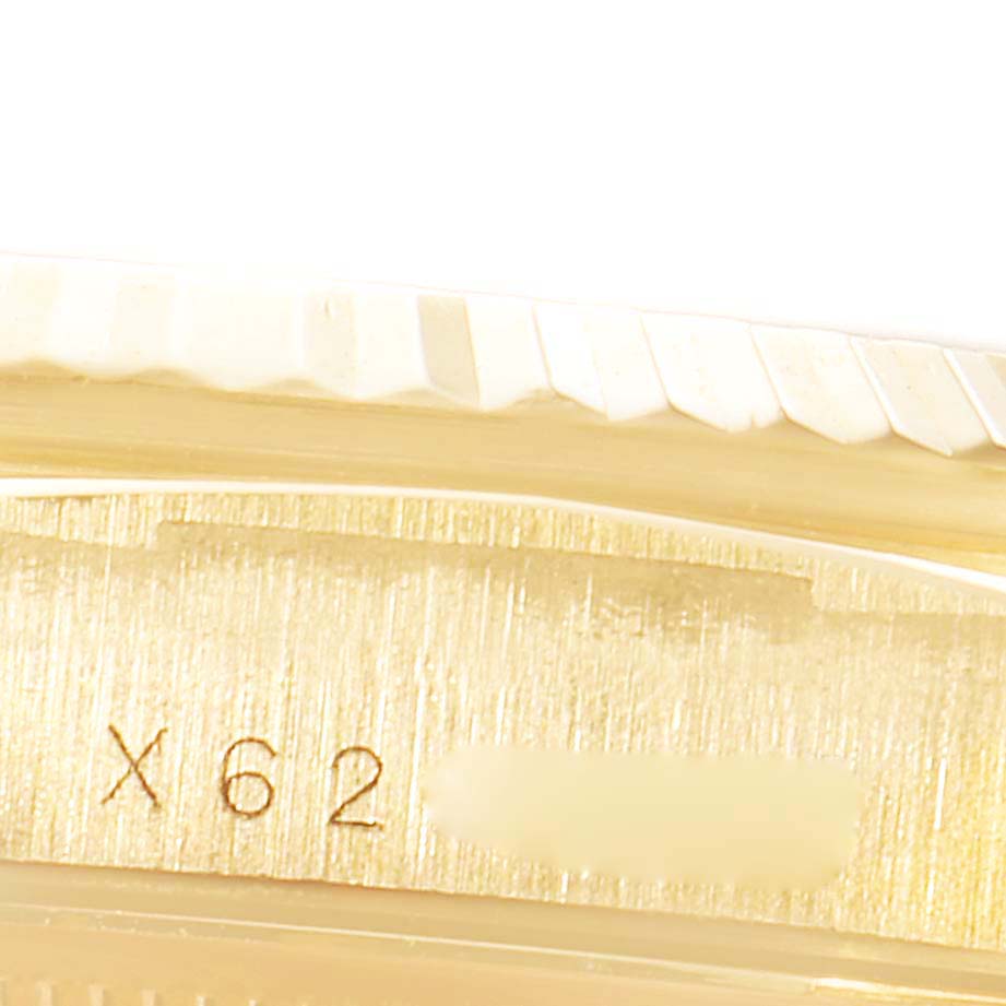 This image shows a close-up view of the side of a Rolex President 18238 Men's Yellow Gold White Dial 18238 Men's Yellow Gold White Dial model watch, focusing on the serial number engraving.