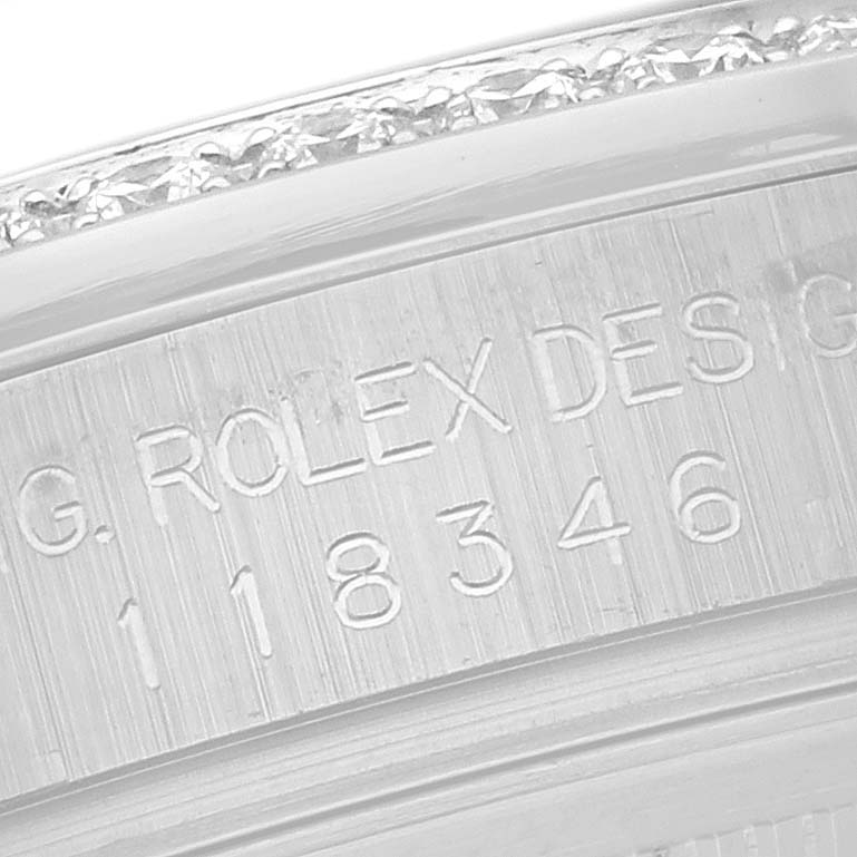 This image shows a close-up of the etched serial number and design engraving on the inner bezel of a Rolex President 118346 Men's Platinum Silver Dial 118346 Men's Platinum Silver Dial model watch.