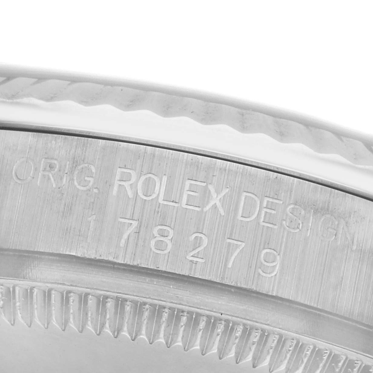 The image shows a close-up of the side engraving on the bezel of a Rolex Mid-Size 178279 Women
s White Gold Silver Dial 178279 Women
s White Gold Silver Dial model, displaying "ORIG. ROLEX DESIGN" and numbers.