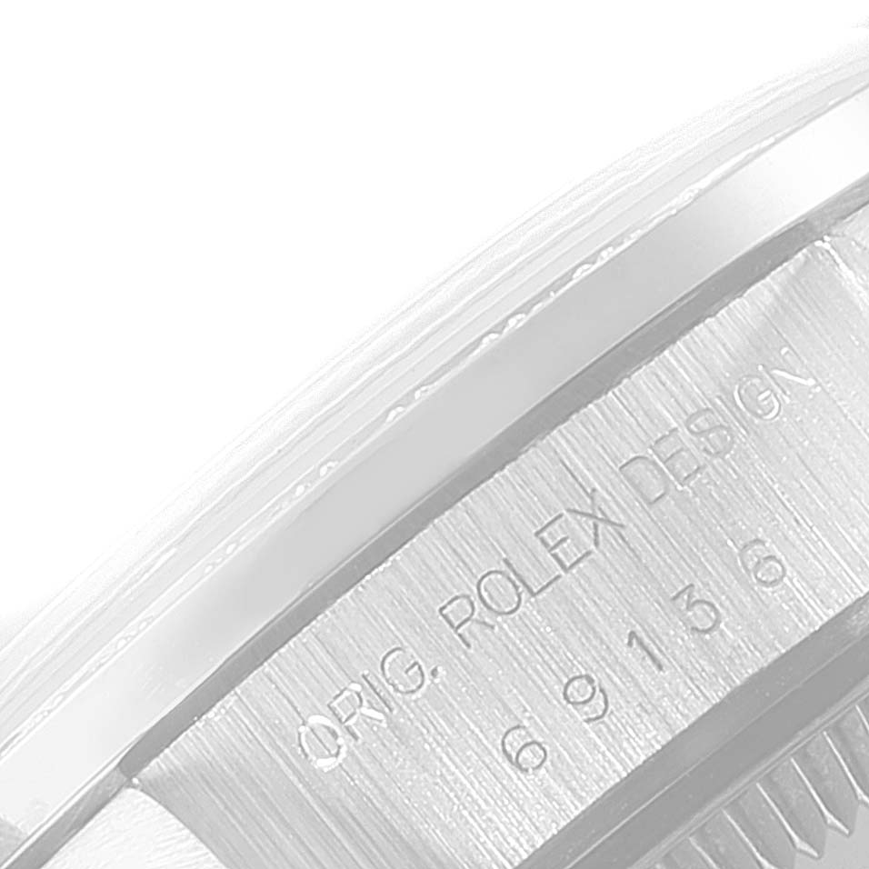 This image shows a close-up angle of a Rolex President 69136 Women's Platinum Silver Dial 69136 Women's Platinum Silver Dial model's case side, displaying engraved details.