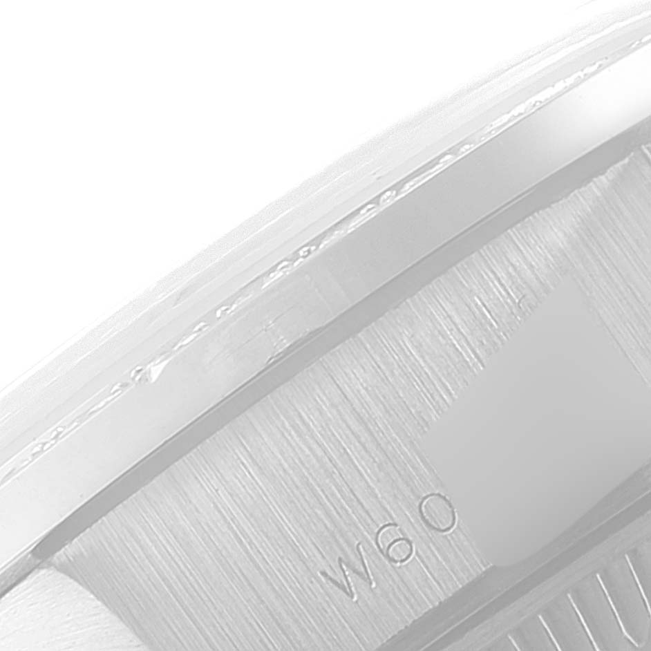 This close-up angle shows the edge of the case and part of the bezel engraving on a Rolex President 69136 Women's Platinum Silver Dial 69136 Women's Platinum Silver Dial model watch.