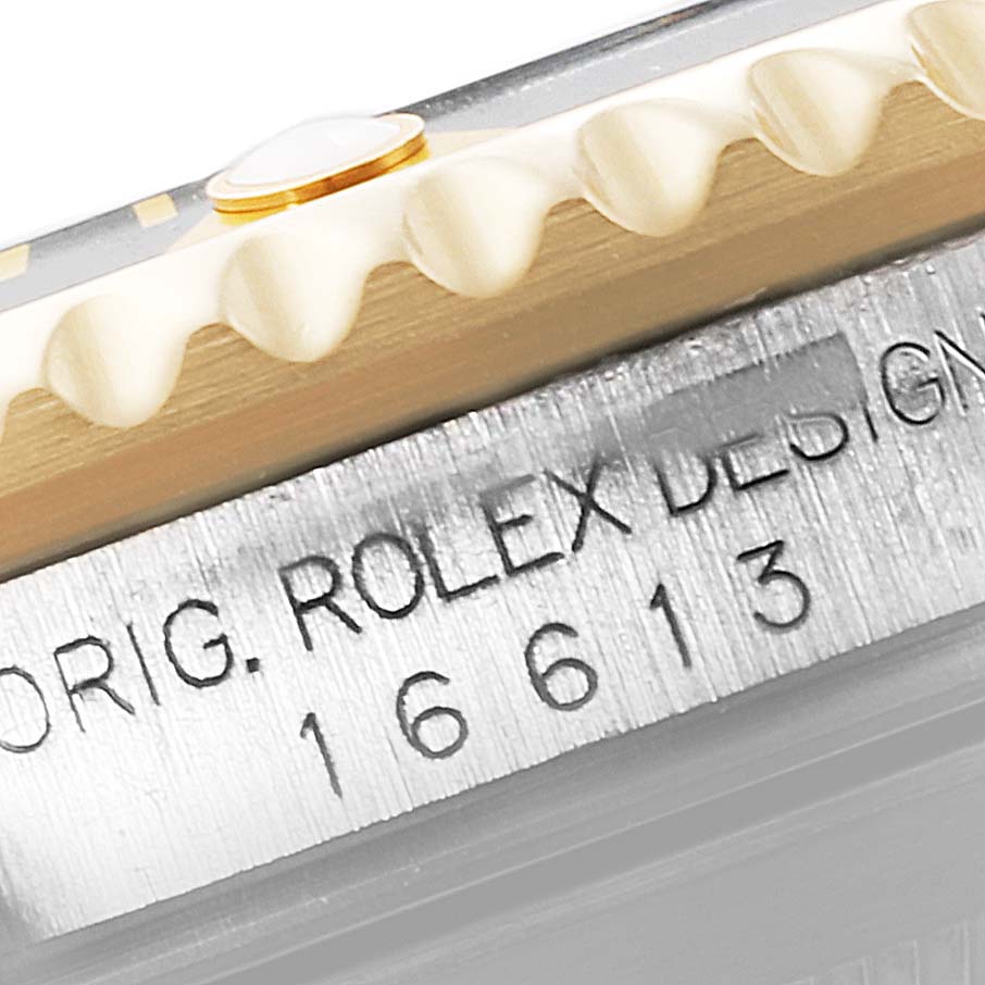 This image shows a close-up of the bezel and engraved case side of a Rolex Submariner 16613 Men
s Steel and Gold (two tone) Black Dial 16613 Men
s Steel and Gold (two tone) Black Dial, highlighting the model number 16613.