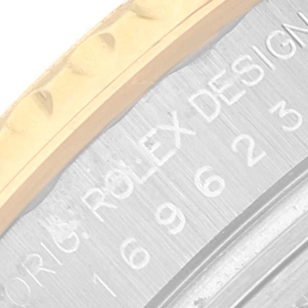 The image shows a detailed close-up of the engraved Rolex Yacht-Master 169623 Women's Steel and Gold (two tone) Champagne Dial 169623 Women's Steel and Gold (two tone) Champagne Dial model's bezel and case side.