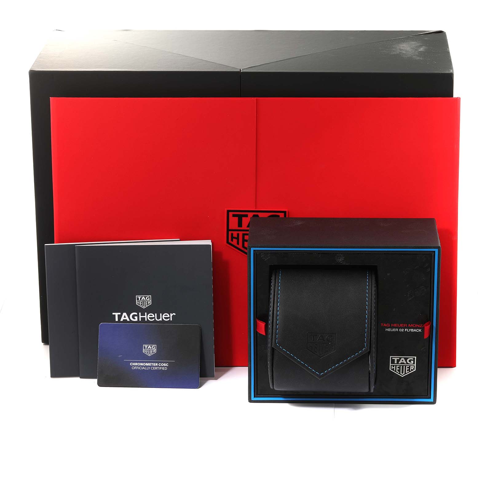 This image shows the packaging and accessories for the Tag Heuer Monza CR5090.FN6001 Men's Titanium Black Dial CR5090.FN6001 Men's Titanium Black Dial model watch, including booklets, a card, and a watch case.