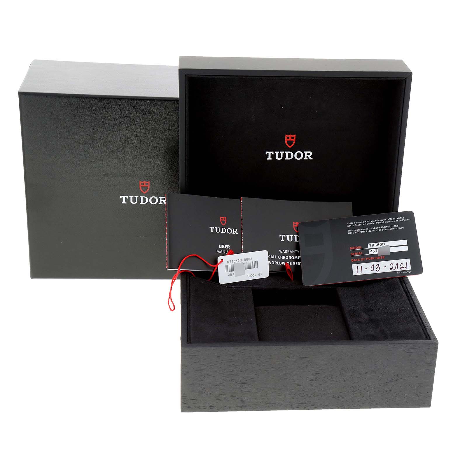 The image shows the packaging and accessories for a Tudor Heritage Black Bay 79360N Men
s Stainless Steel White Dial 79360N Men
s Stainless Steel White Dial watch, including the box, manuals, tags, and warranty card.