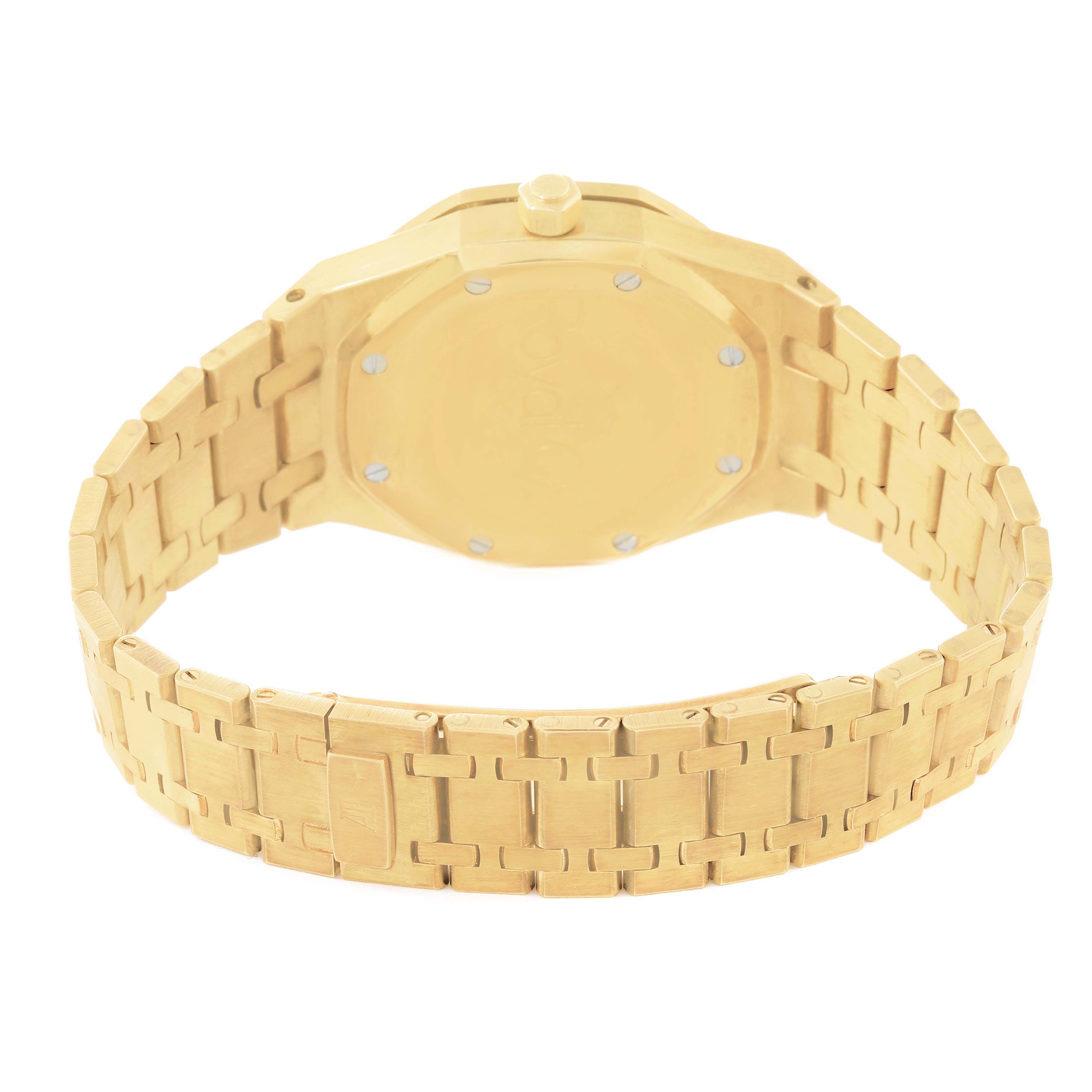 The image shows the rear view of an Audemars Piguet Royal Oak 25730BA Men's Yellow Gold Silver Dial 25730BA Men's Yellow Gold Silver Dial watch, detailing its gold bracelet and back case.