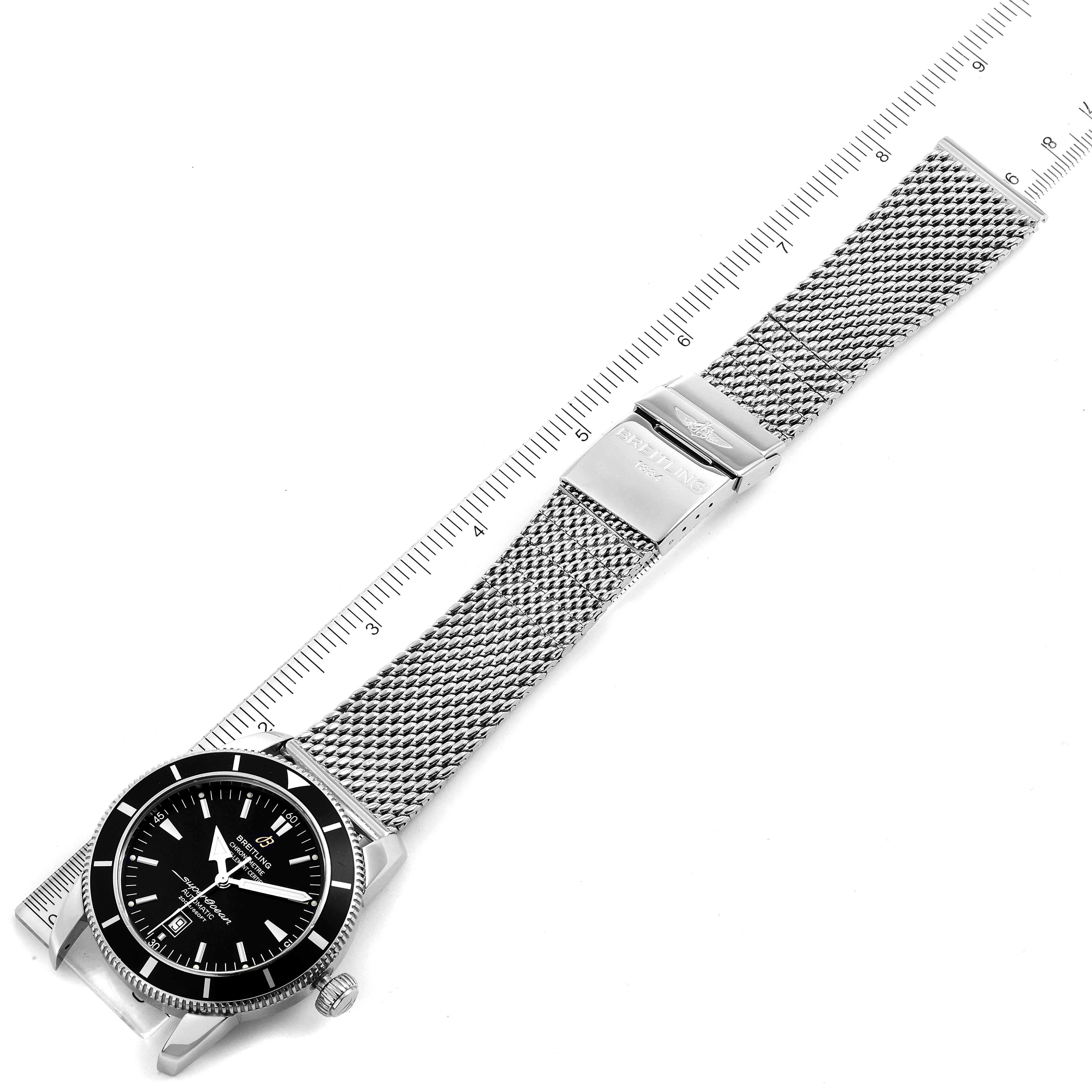 This image shows the full view of a Breitling Superocean A17320 Men
s Stainless Steel Black Dial A17320 Men
s Stainless Steel Black Dial watch lying flat, with a ruler alongside for scale.