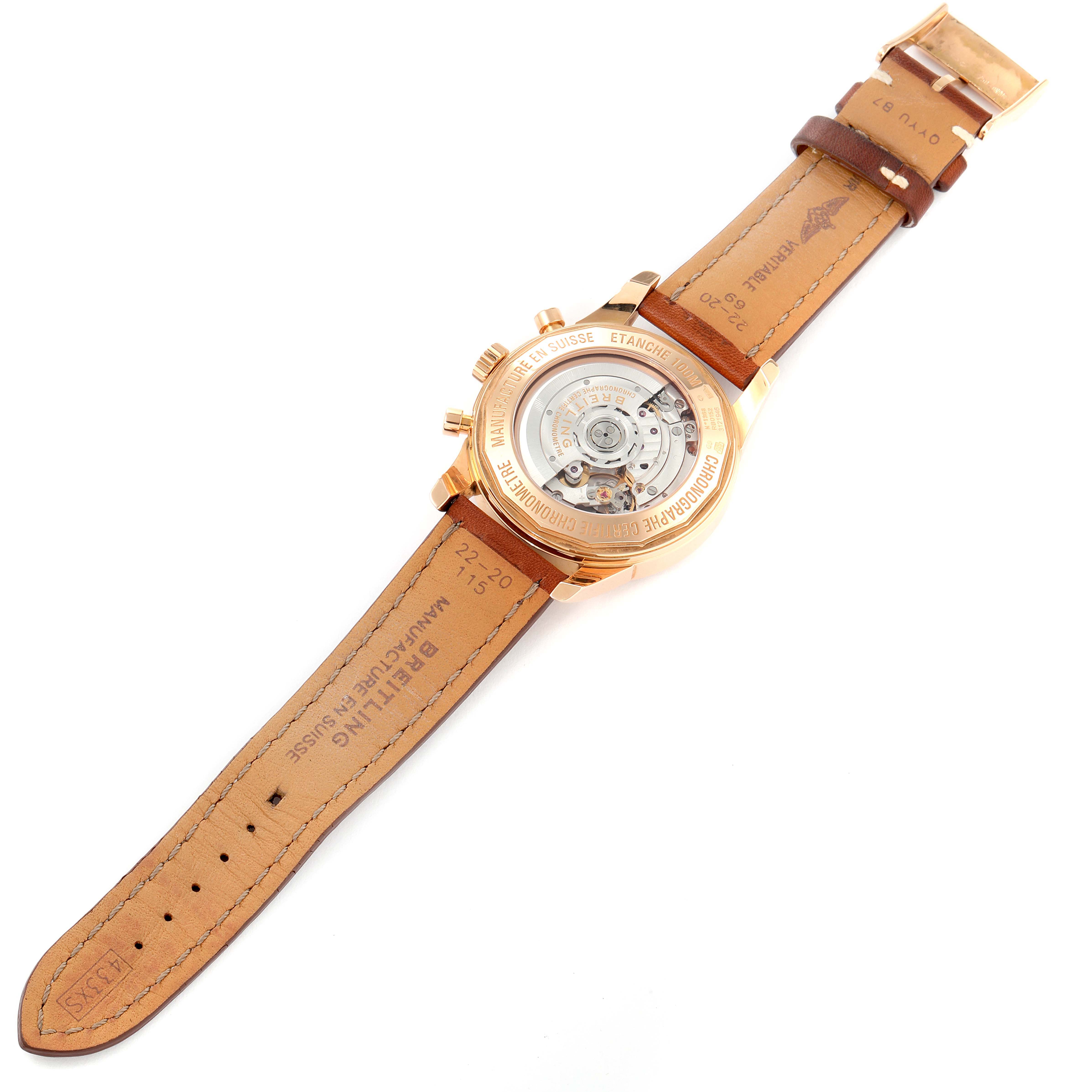 The image shows the back view of a Breitling Transocean RB0152 Men's Rose Gold Silver Dial RB0152 Men's Rose Gold Silver Dial watch, highlighting its leather strap and exposed mechanical movement.