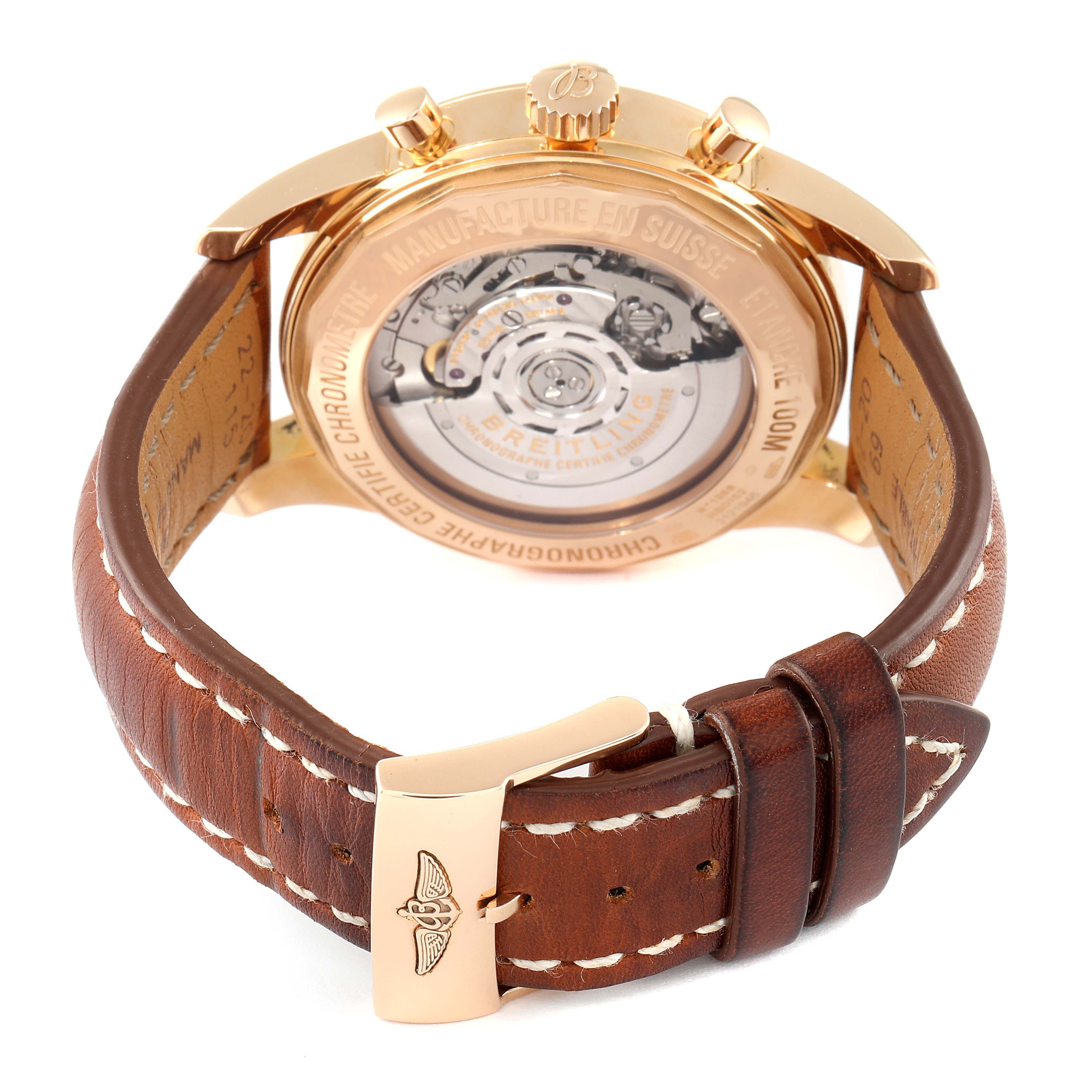 The image shows the back and side view of the Breitling Transocean RB0152 Men's Rose Gold Silver Dial RB0152 Men's Rose Gold Silver Dial watch, highlighting its movement and leather strap with a deployment clasp.