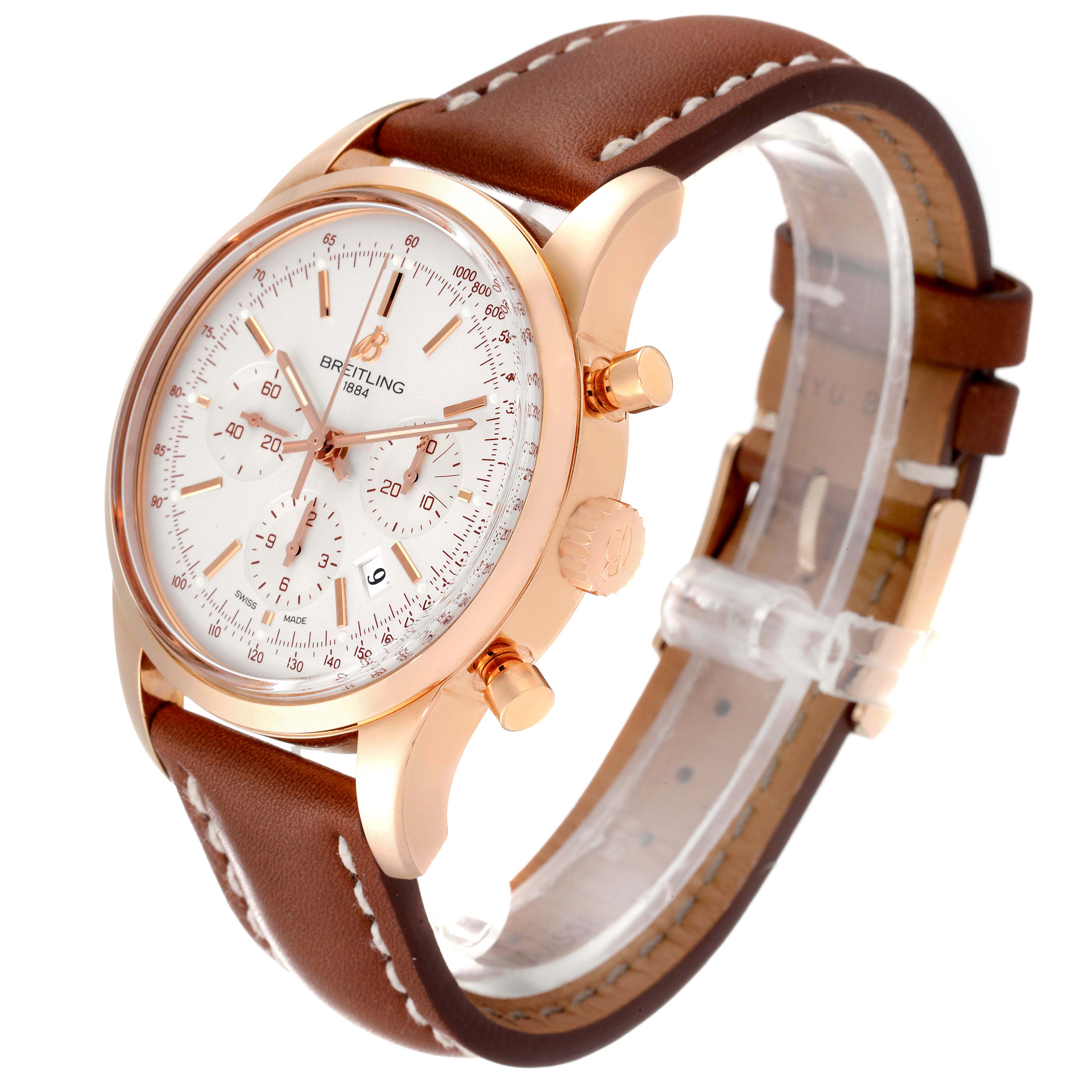 The image shows a side-angle view of a Breitling Transocean RB0152 Men's Rose Gold Silver Dial RB0152 Men's Rose Gold Silver Dial watch, highlighting its dial, crown, pushers, and brown leather strap.