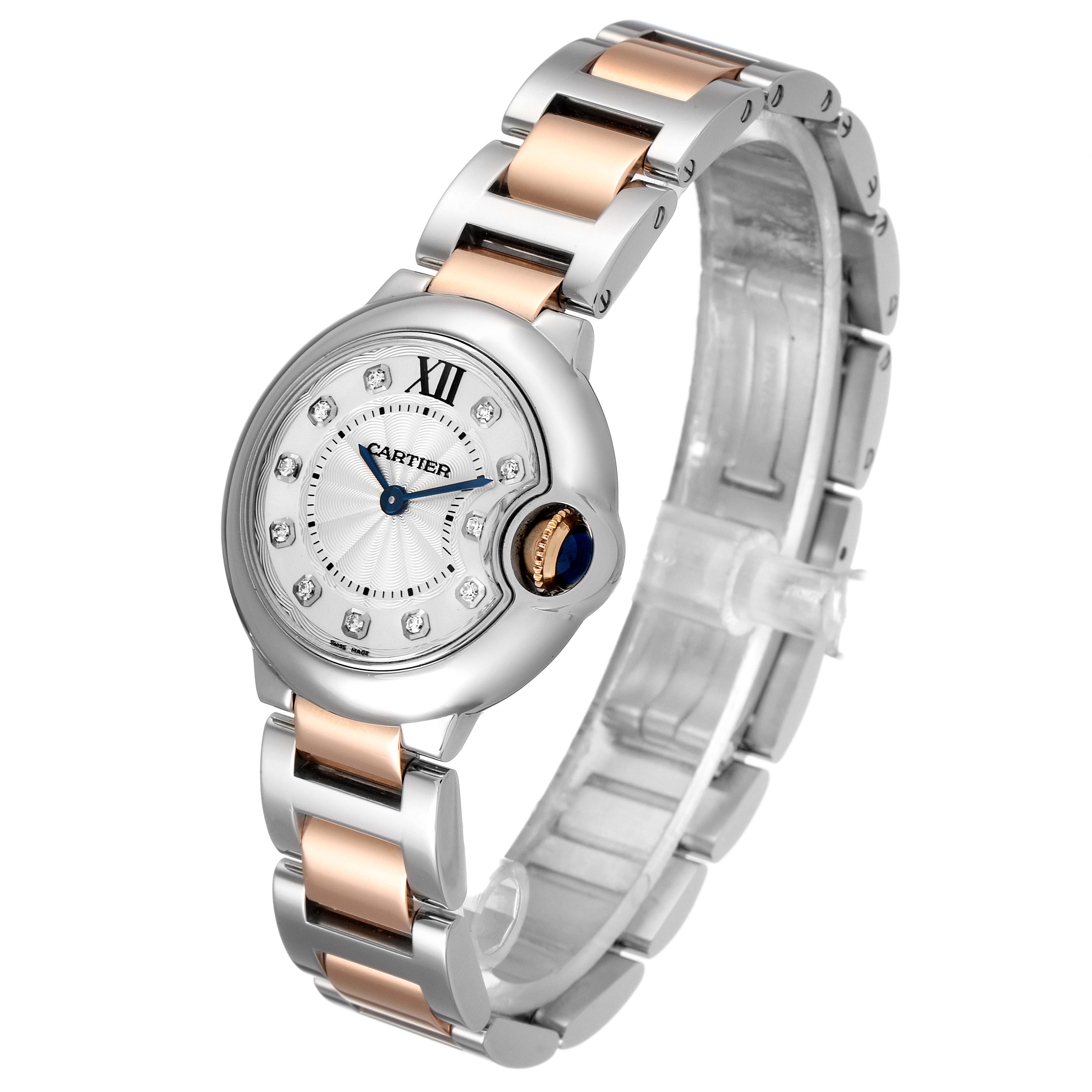 The image shows a Cartier Ballon Bleu WE902030 Women
s Steel and Gold (two tone) Silver Dial WE902030 Women
s Steel and Gold (two tone) Silver Dial watch, angled from the front and side, highlighting its face and two-tone bracelet.