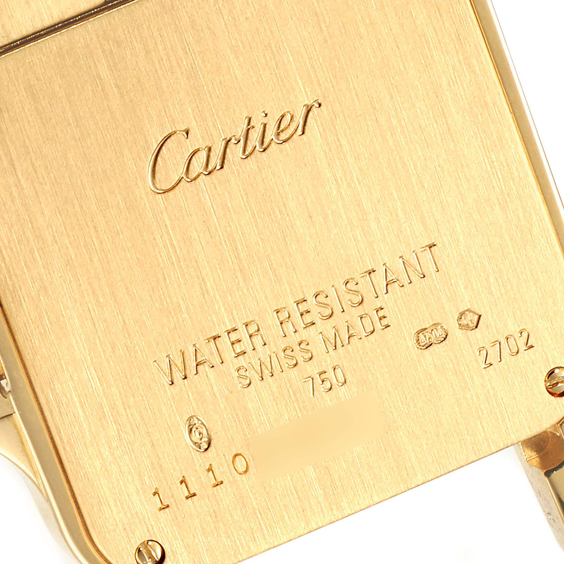 This image shows a close-up view of the back case of a Santos model by Cartier, highlighting the engraving and water resistance information.