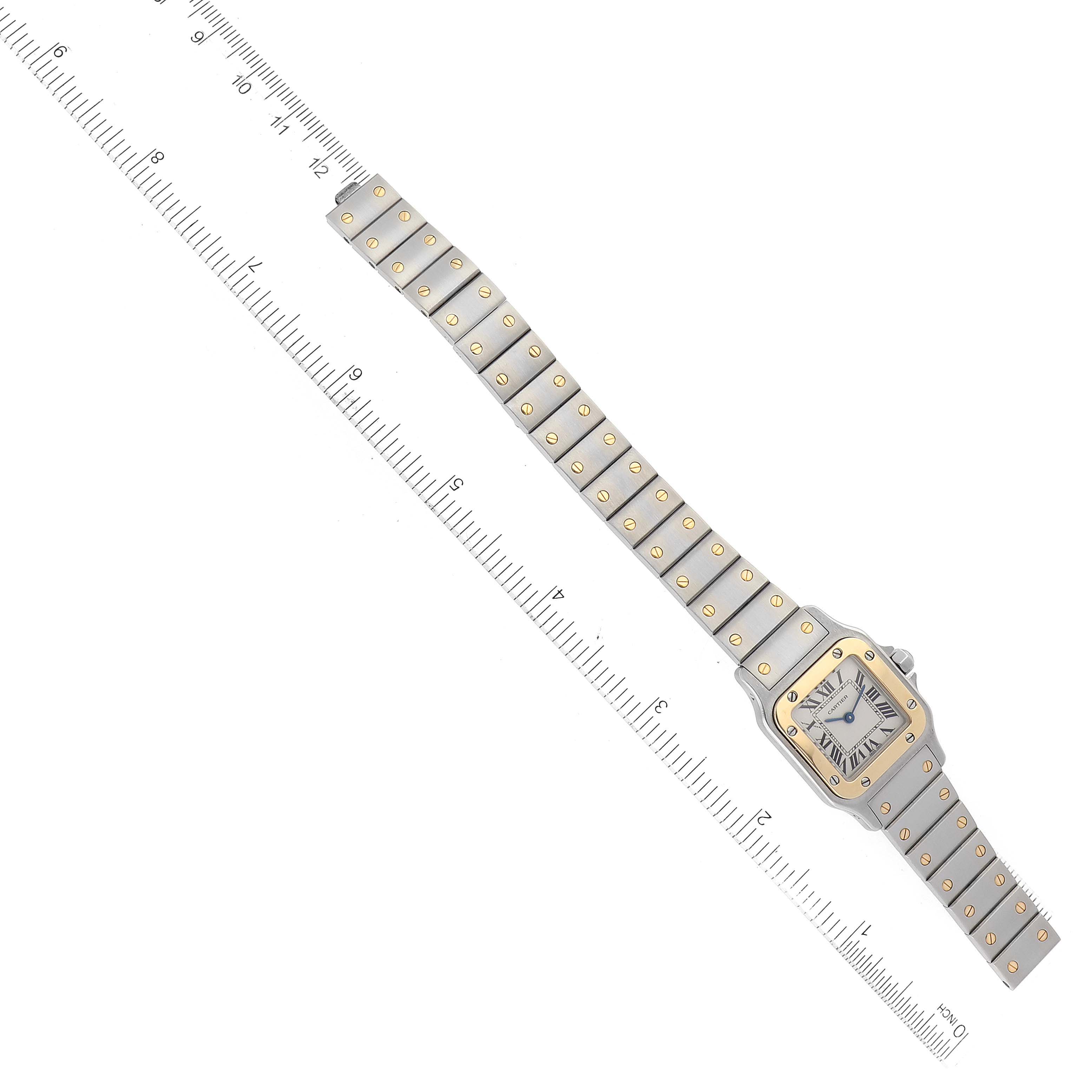 This image shows an overhead view of a Santos model by Cartier, including the full watch and ruler for scale.