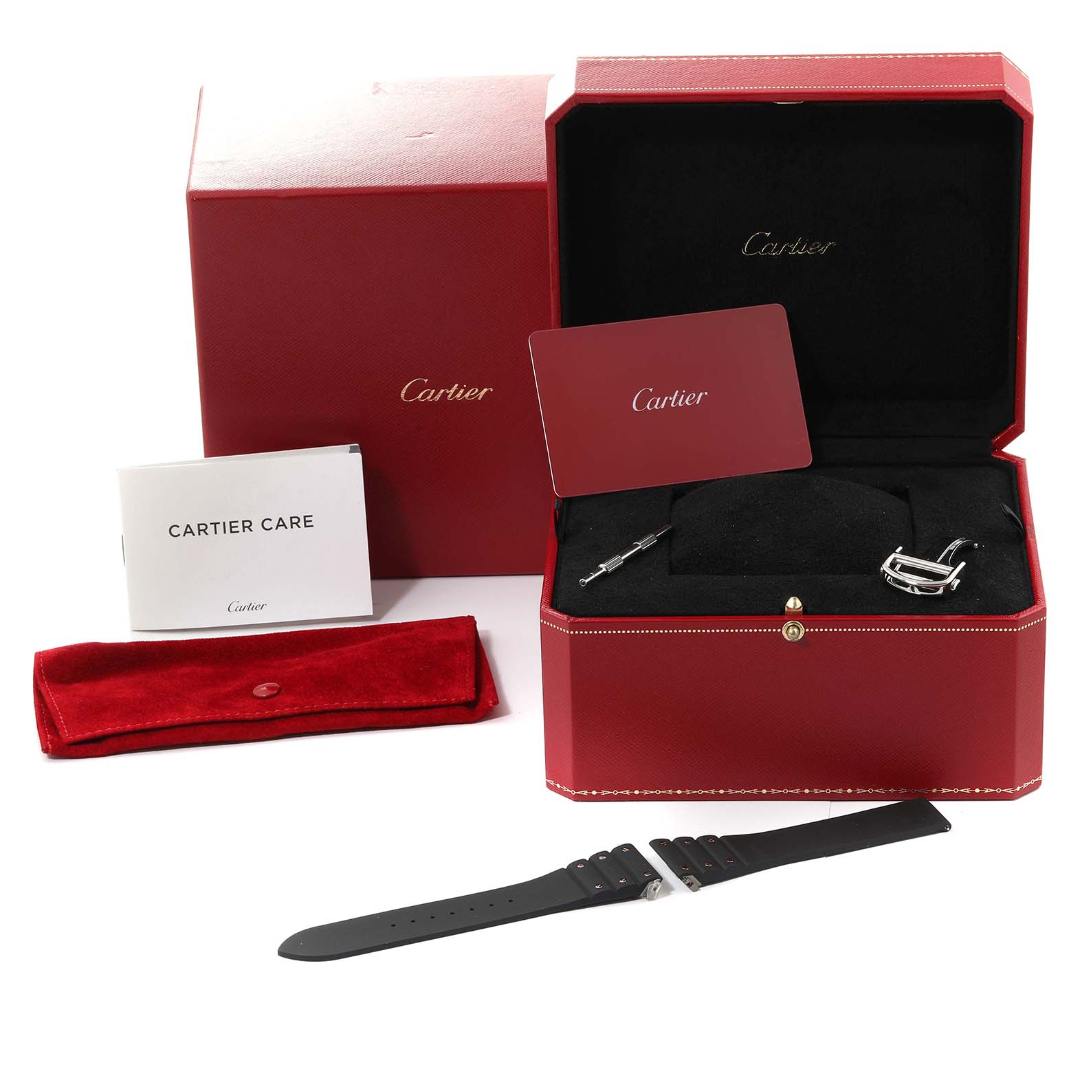 The image shows an unboxed Santos model by Cartier with its accessories, including straps, a bracelet tool, a care booklet, and a presentation case.