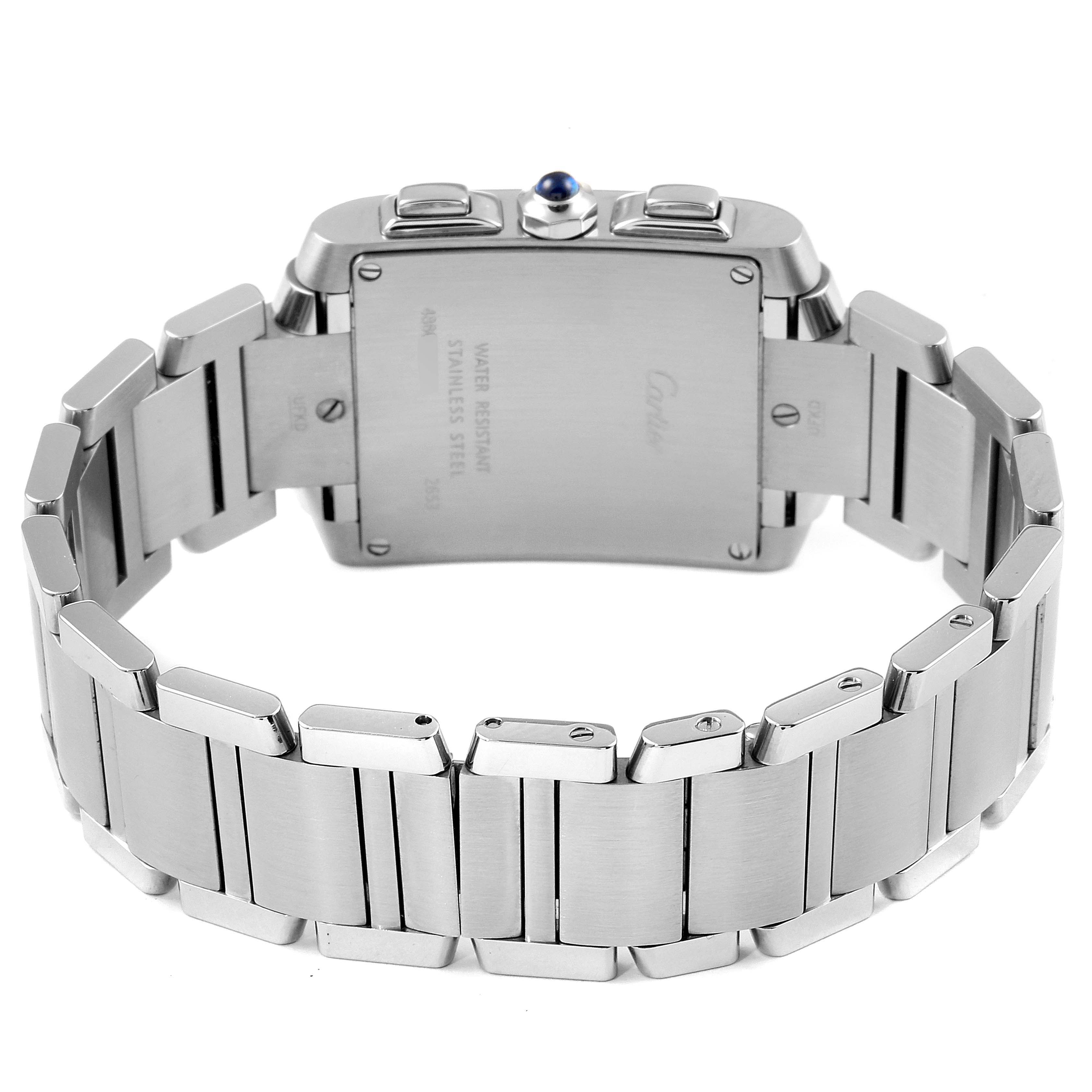 The image shows the backside of a Cartier Tank Française watch, highlighting the stainless steel bracelet and the watch's case back.