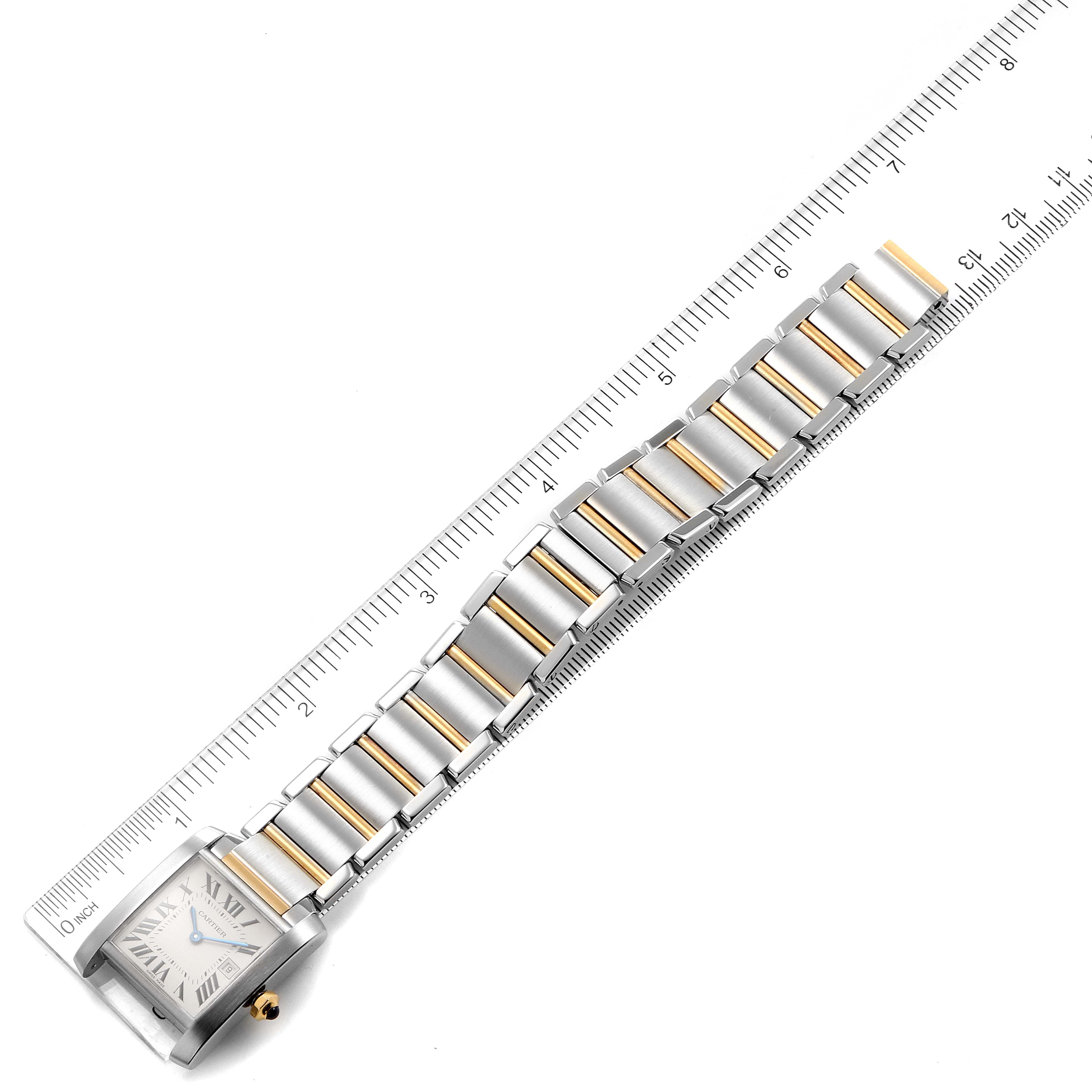 The image shows the Cartier Tank Francaise W51012Q4 Women's Steel and Gold (two tone) Silver Dial W51012Q4 Women's Steel and Gold (two tone) Silver Dial watch laid flat with its metal bracelet fully extended next to a ruler for scale.