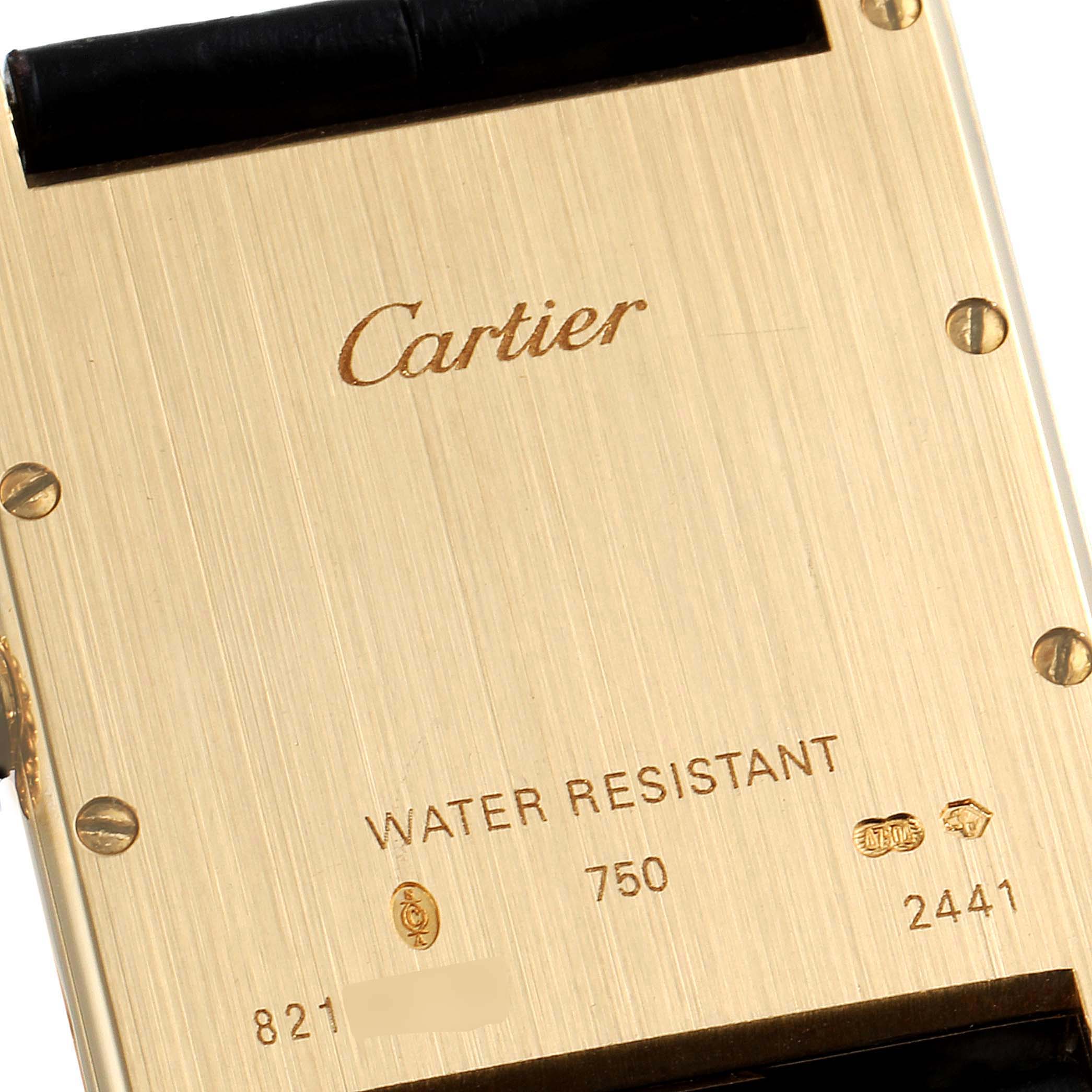 The image shows the back of a Tank Louis watch by Cartier, highlighting the brand name, water resistance, and serial numbers.