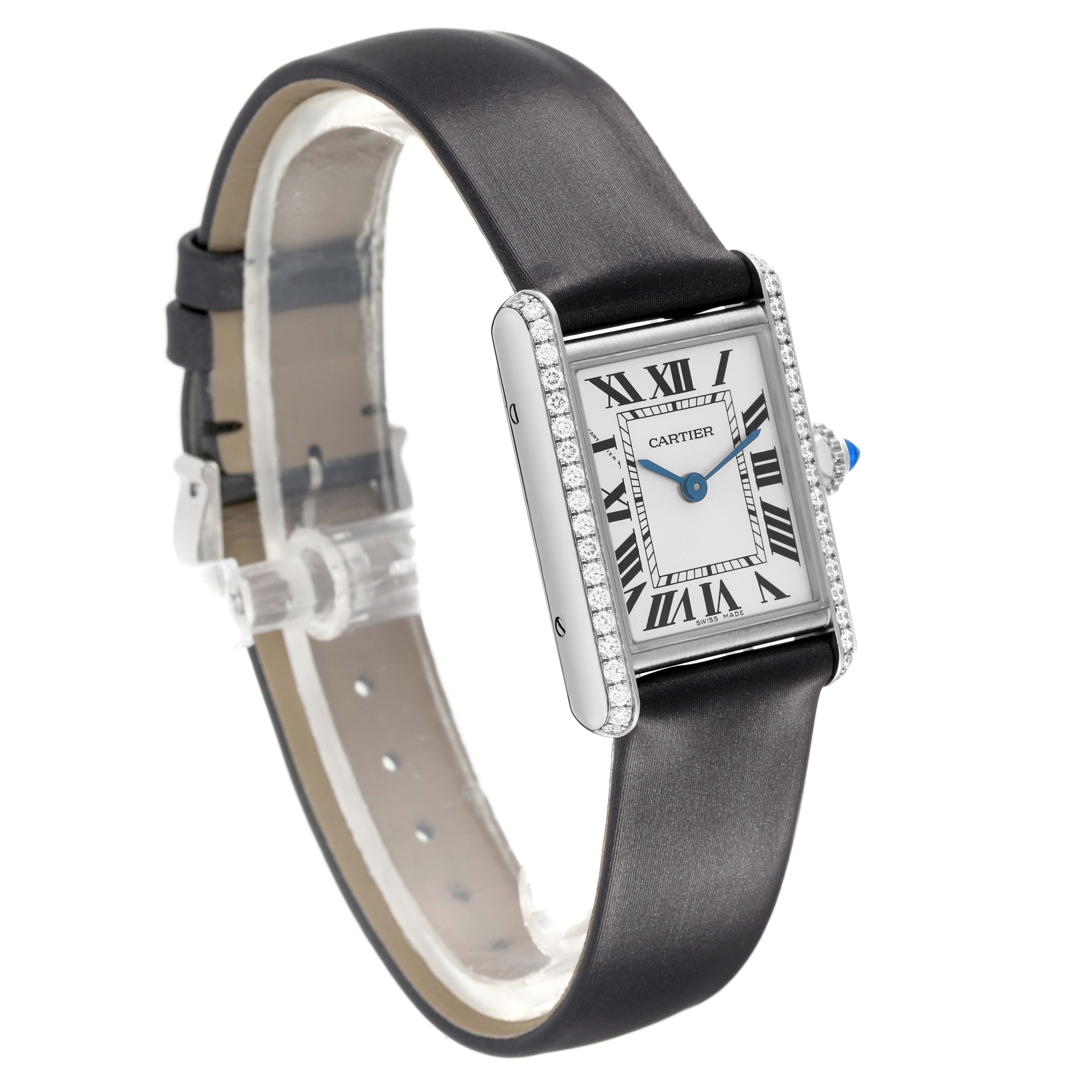 The Cartier Tank Must W4TA0016 Women's Stainless Steel Silver Dial watch is shown at a three-quarter angle, displaying its face, leather strap, and diamond-set bezel.