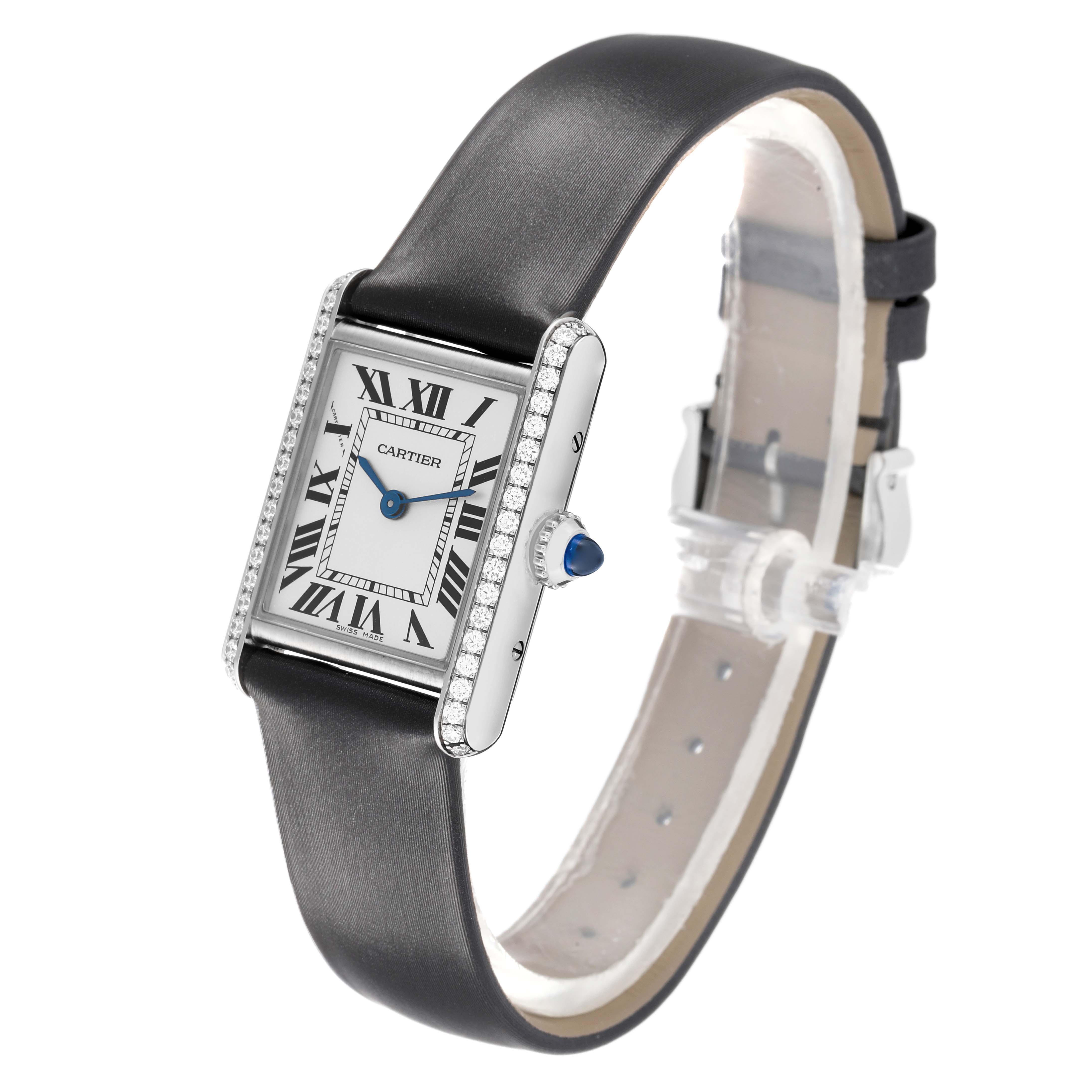 The Cartier Tank Must W4TA0016 Women's Stainless Steel Silver Dial watch is shown at an angle displaying its face, bezel, and strap, highlighting the Roman numeral dial and blue cabochon crown.